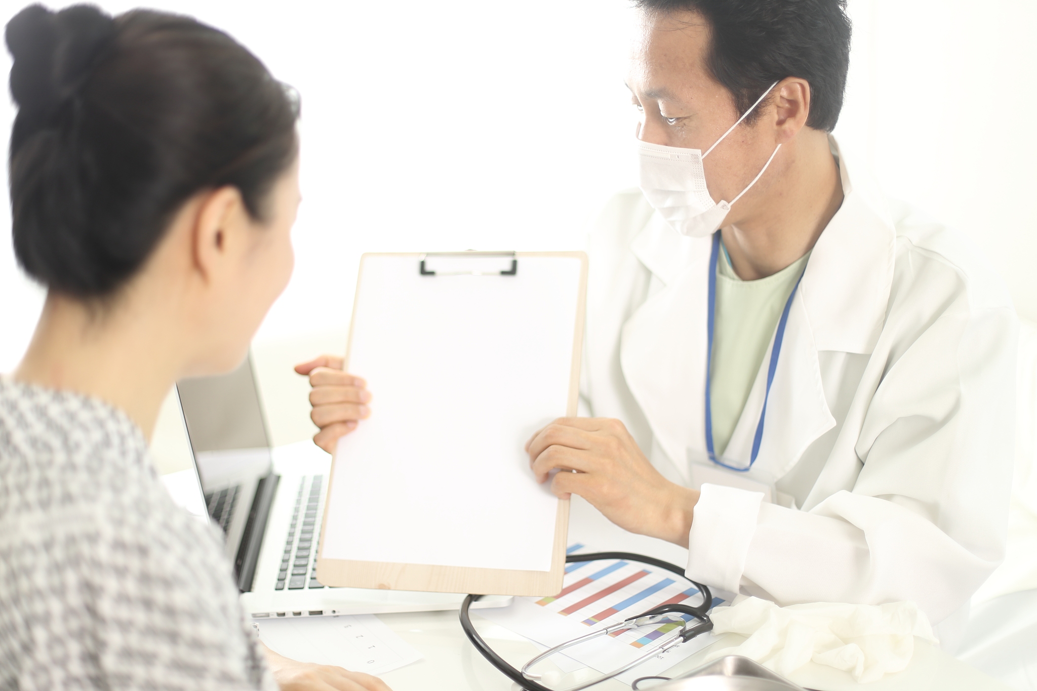 doctor discussing medical record with patient in office