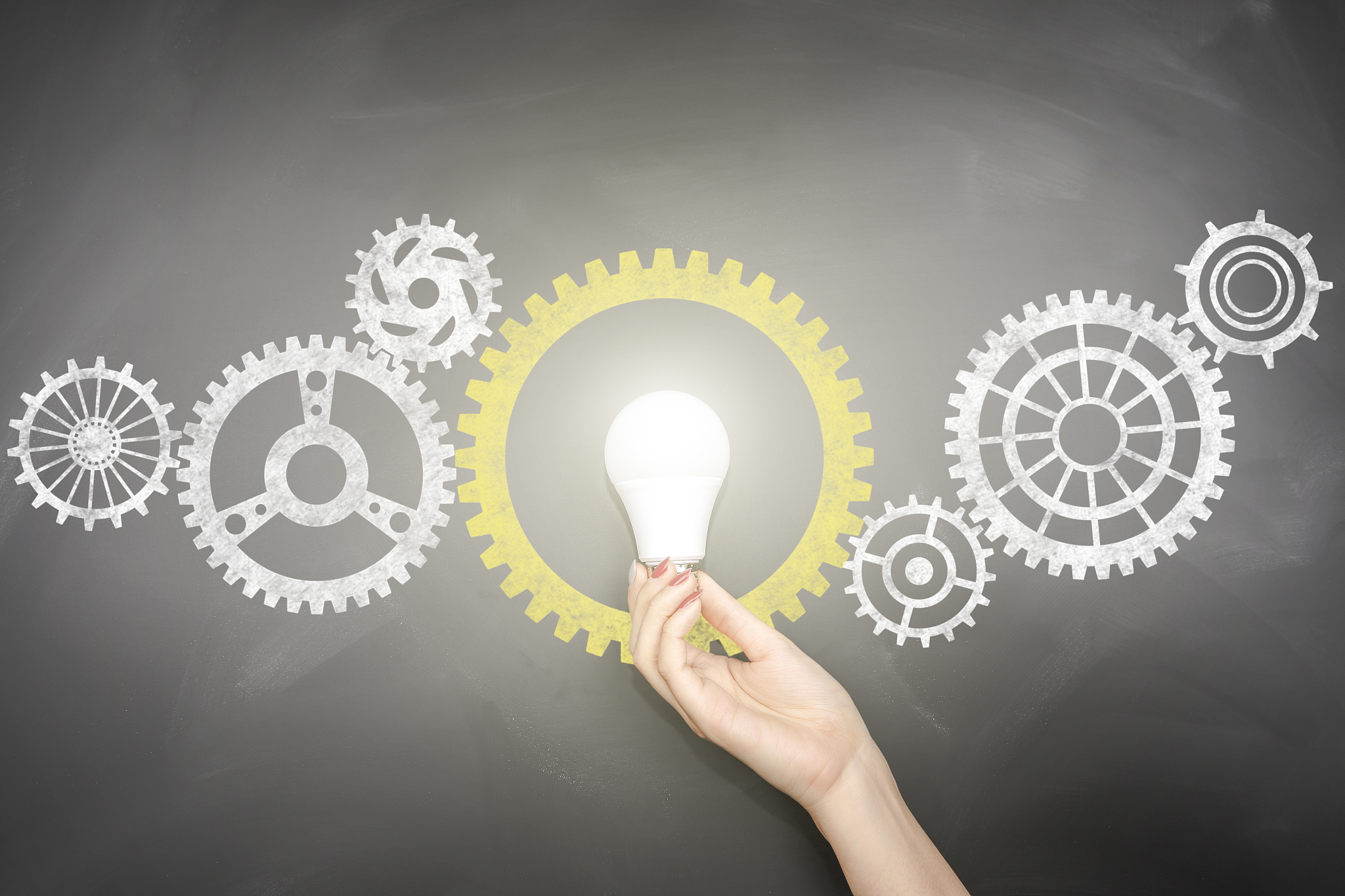 gears - light bulb hand idea blackboard