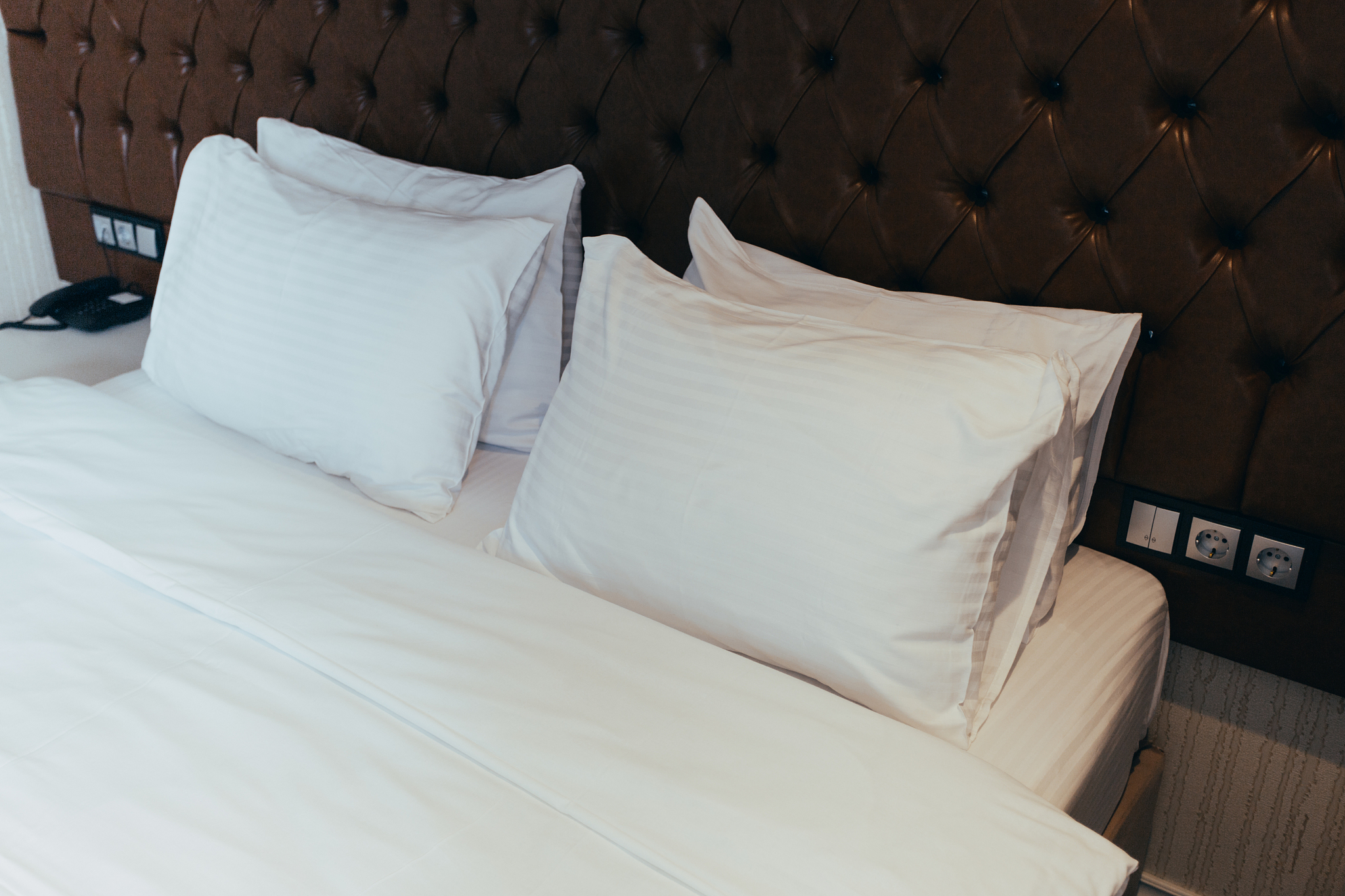 soft white pillows on comfortable bed, closeup