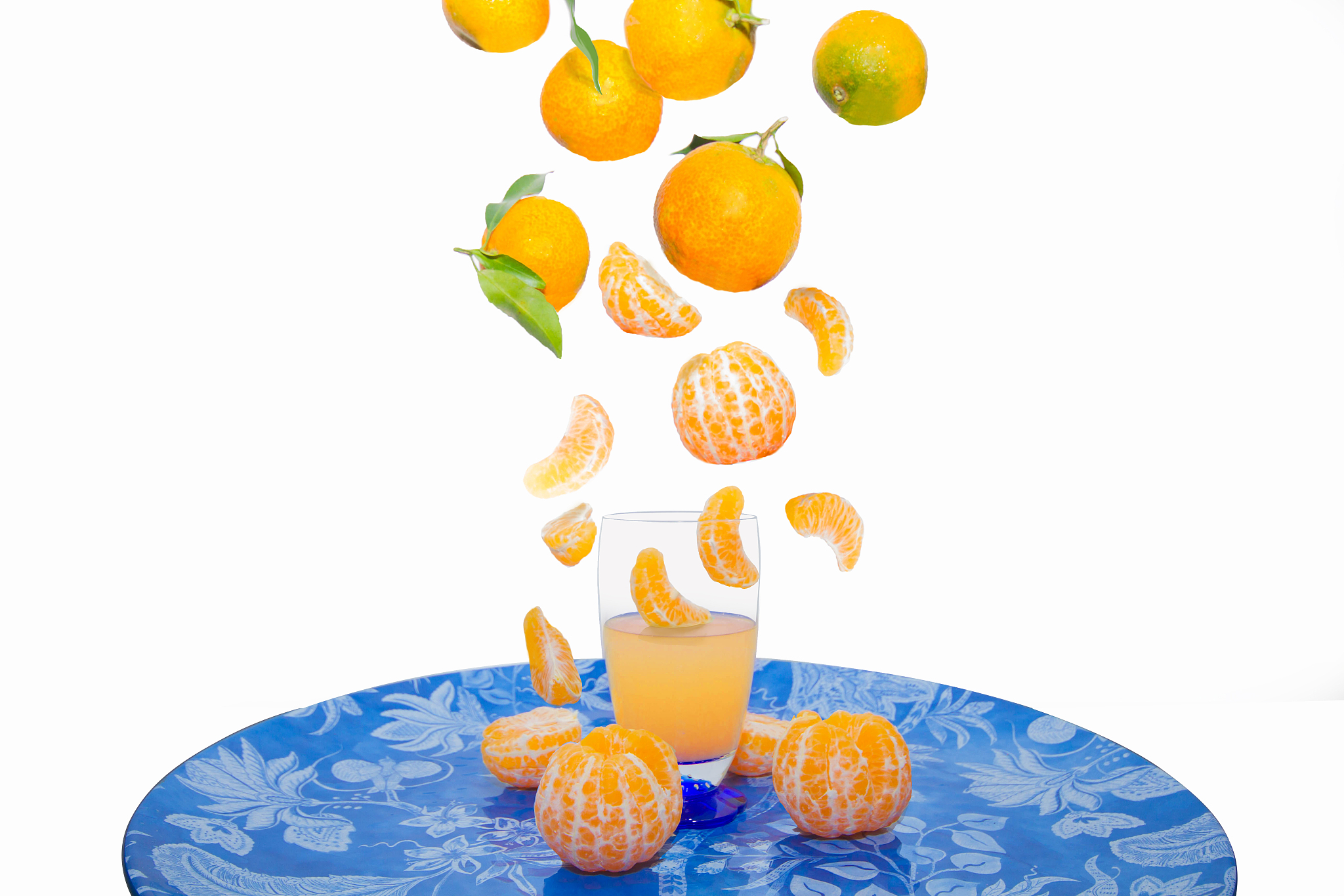 tangerine juice. set of tangerine wedges falling into a glass. v