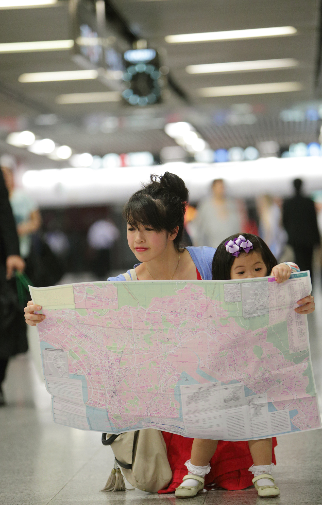 mother and daughter looking at map