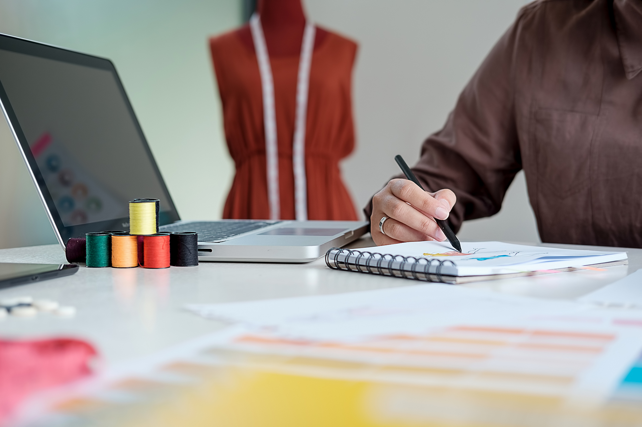 attractive young woman fashion designer standing and working in 