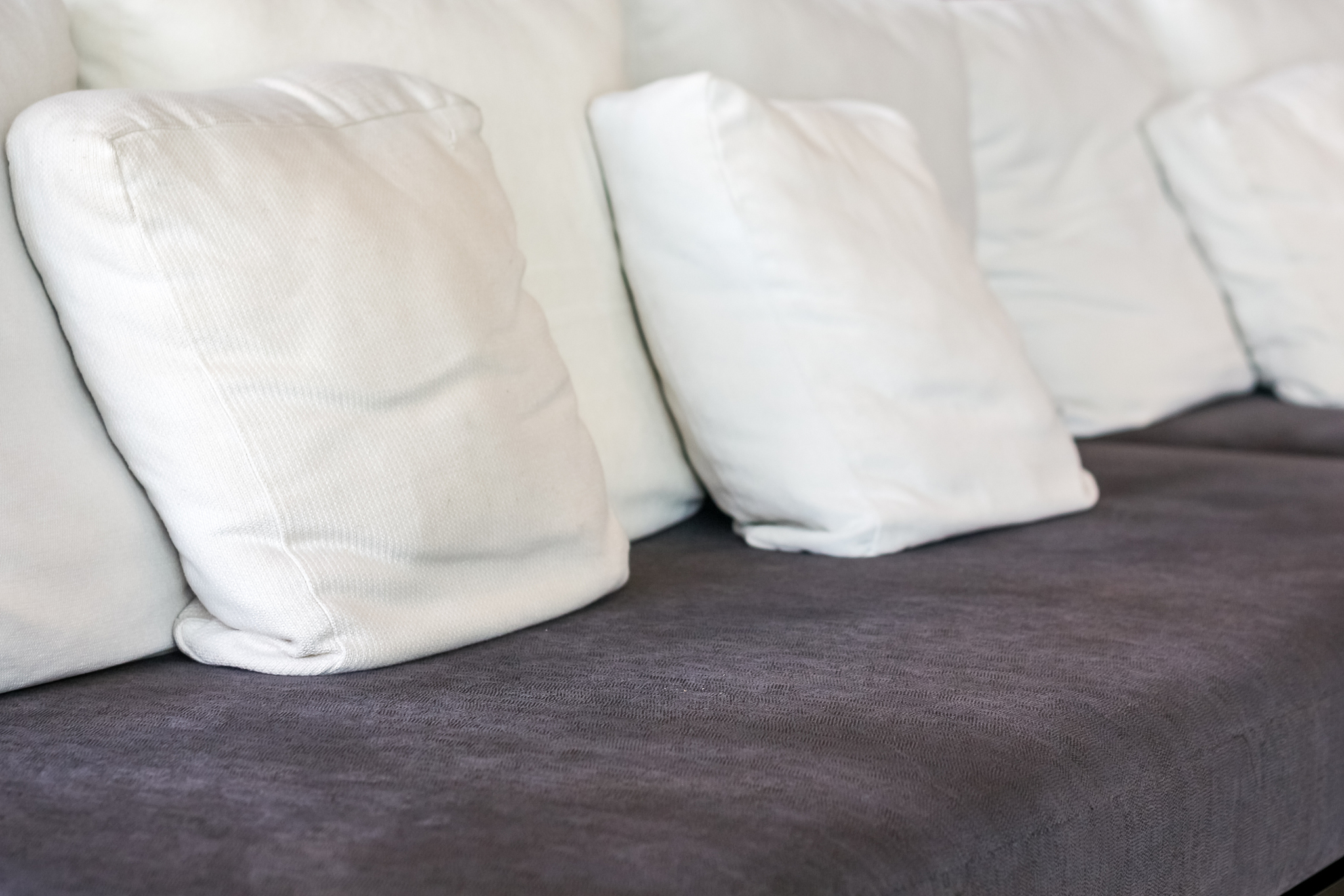 close up white pillow on the brown sofa