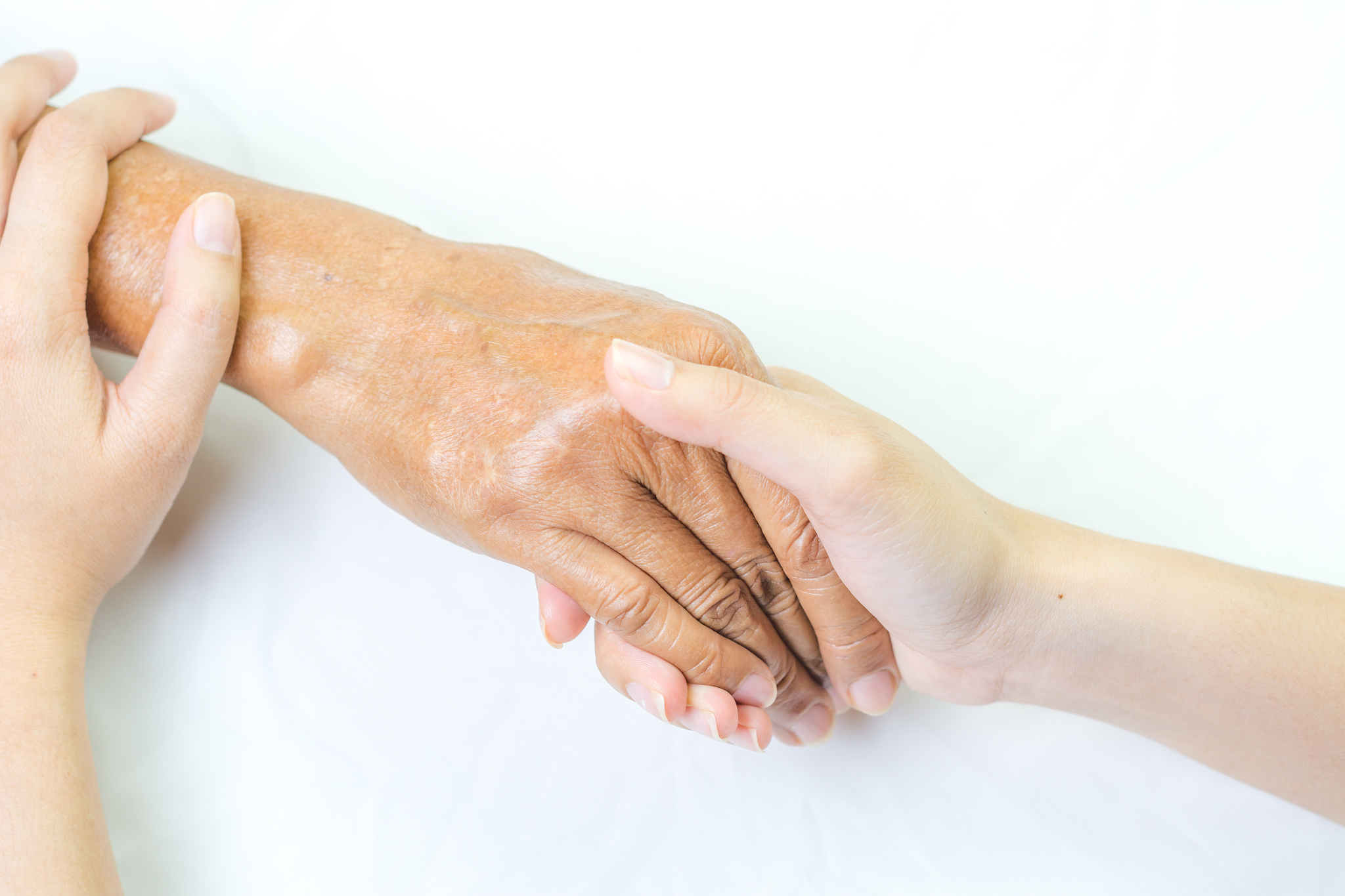 asian senior and asian young holding hands.