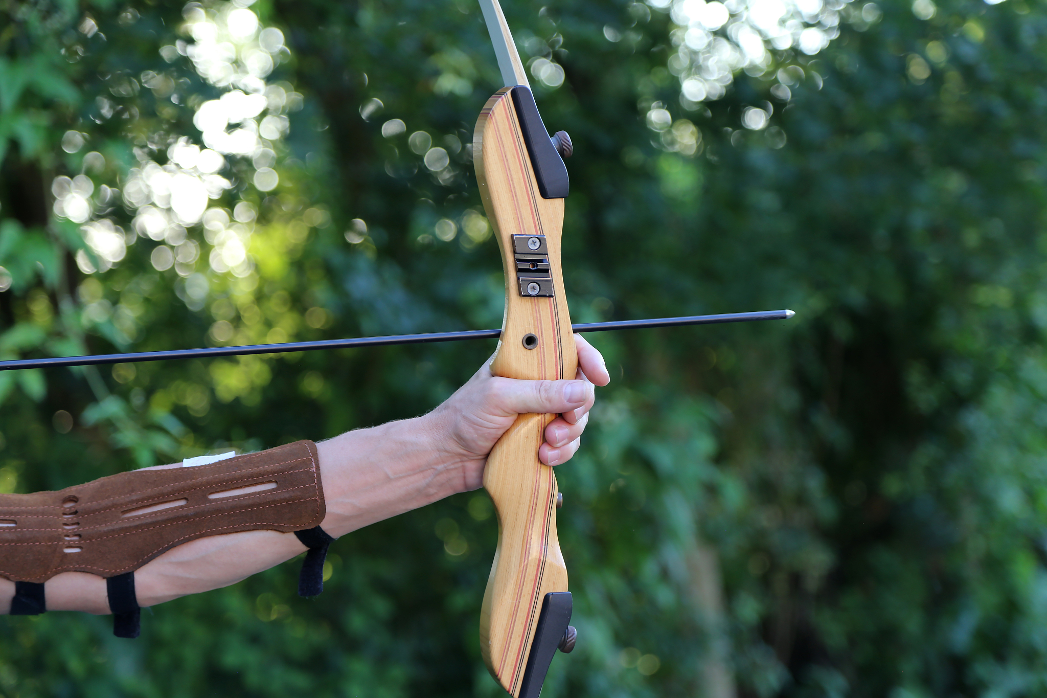 cropped hands of person practicing archery