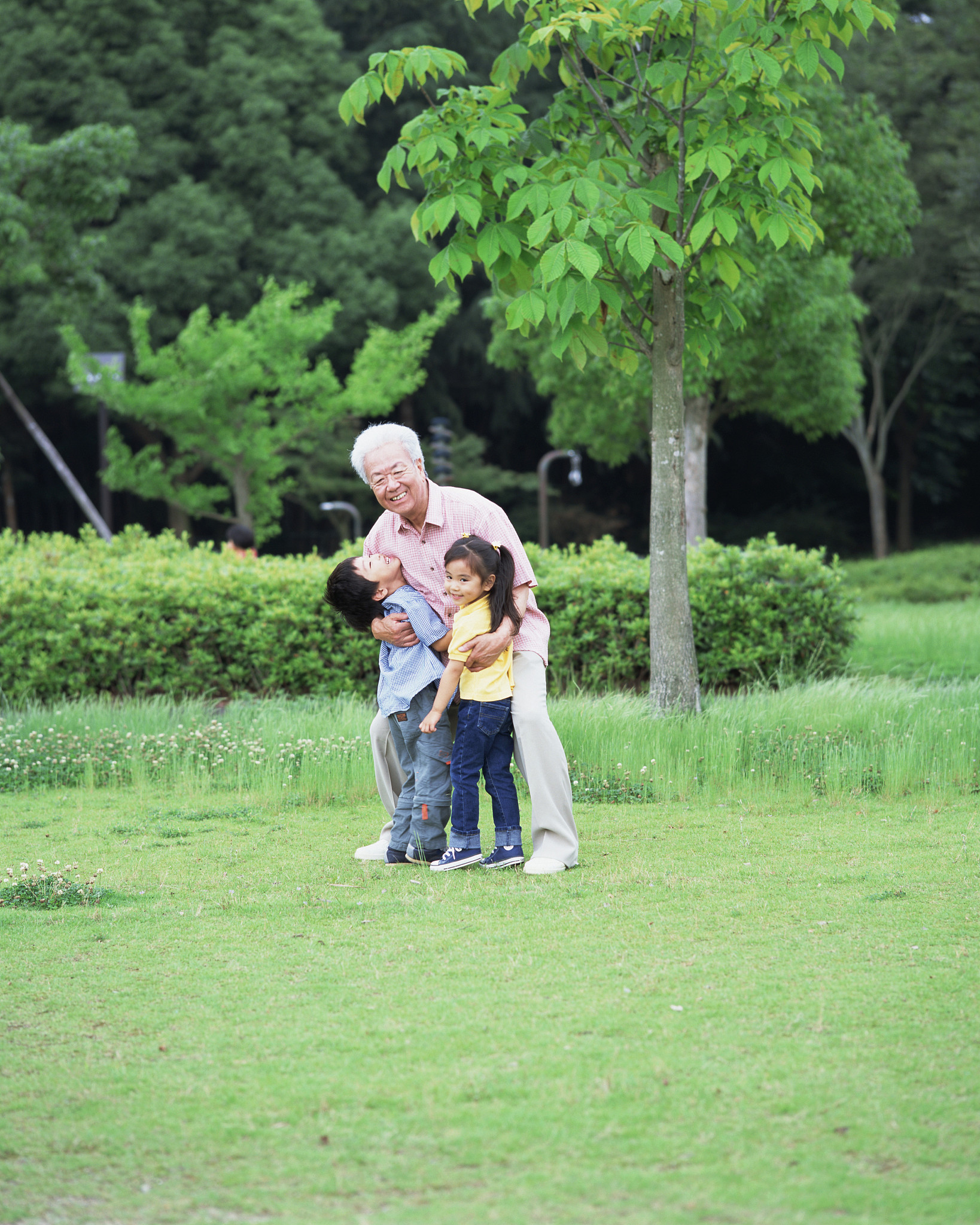 a grand father holding grand children