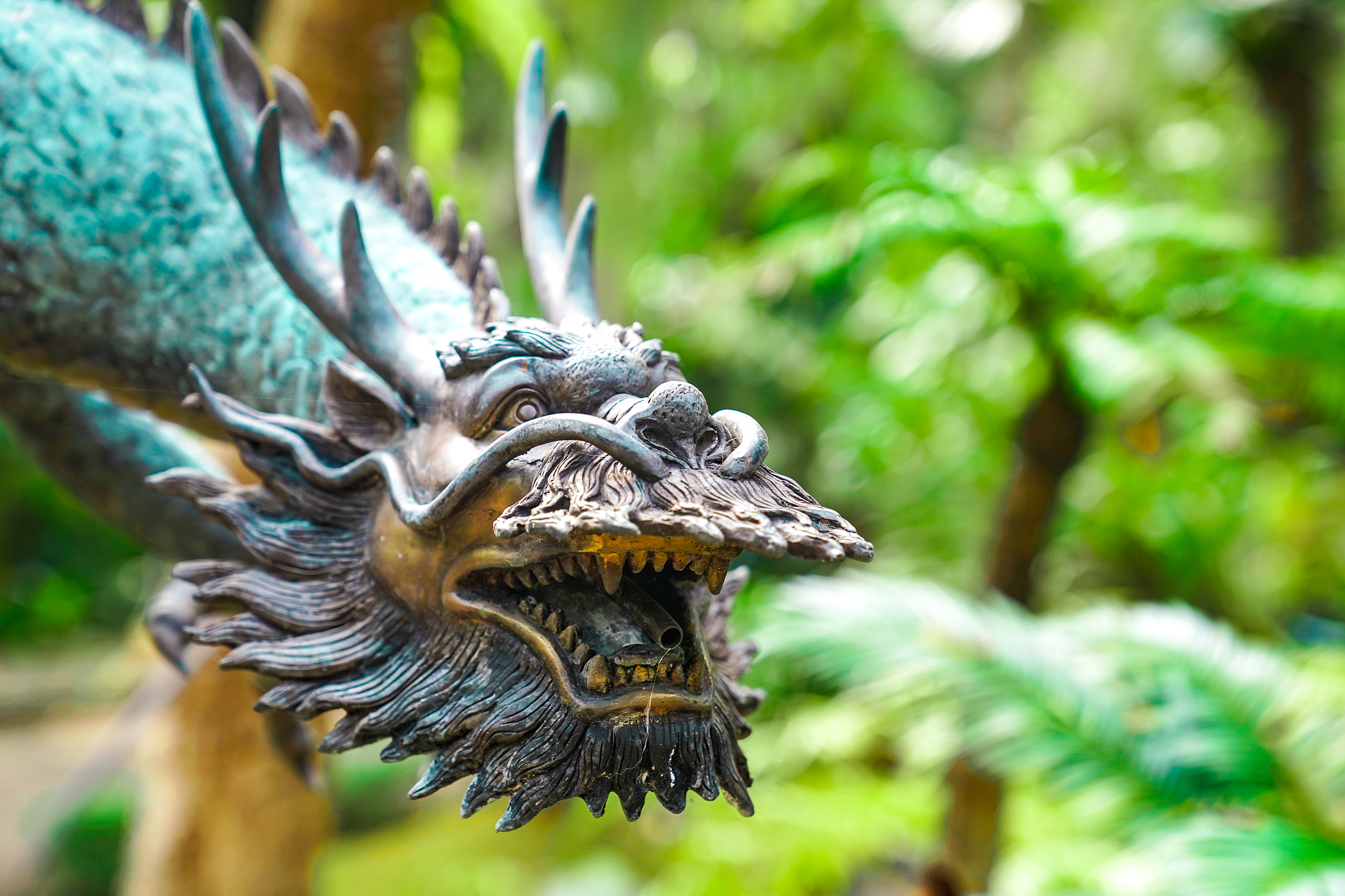 vintage classic statue of asian china dragon sattle in the green