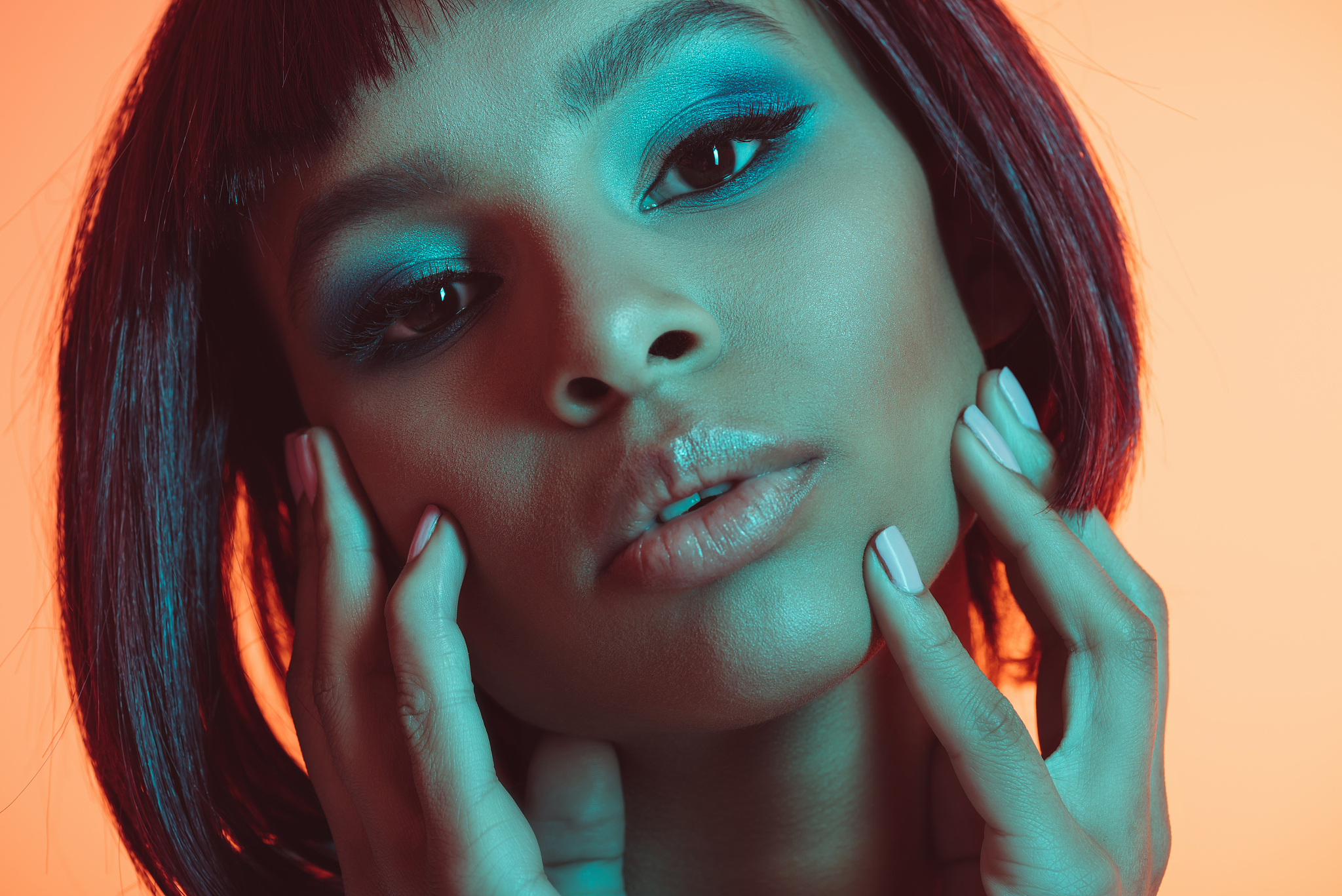 portrait of attractive african american woman with hands on face