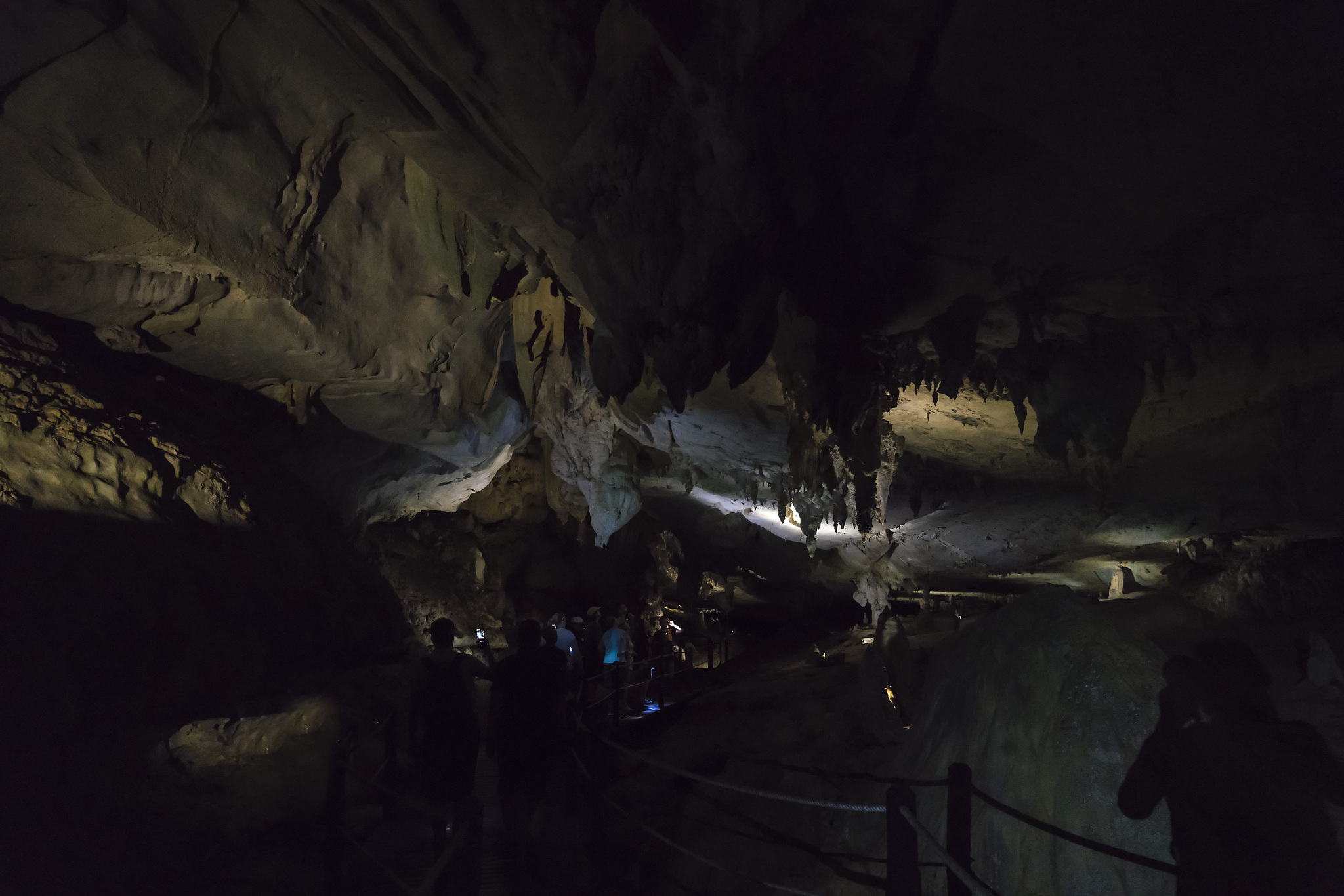 tourist with headlamps in deer cave, gunung mulu national park