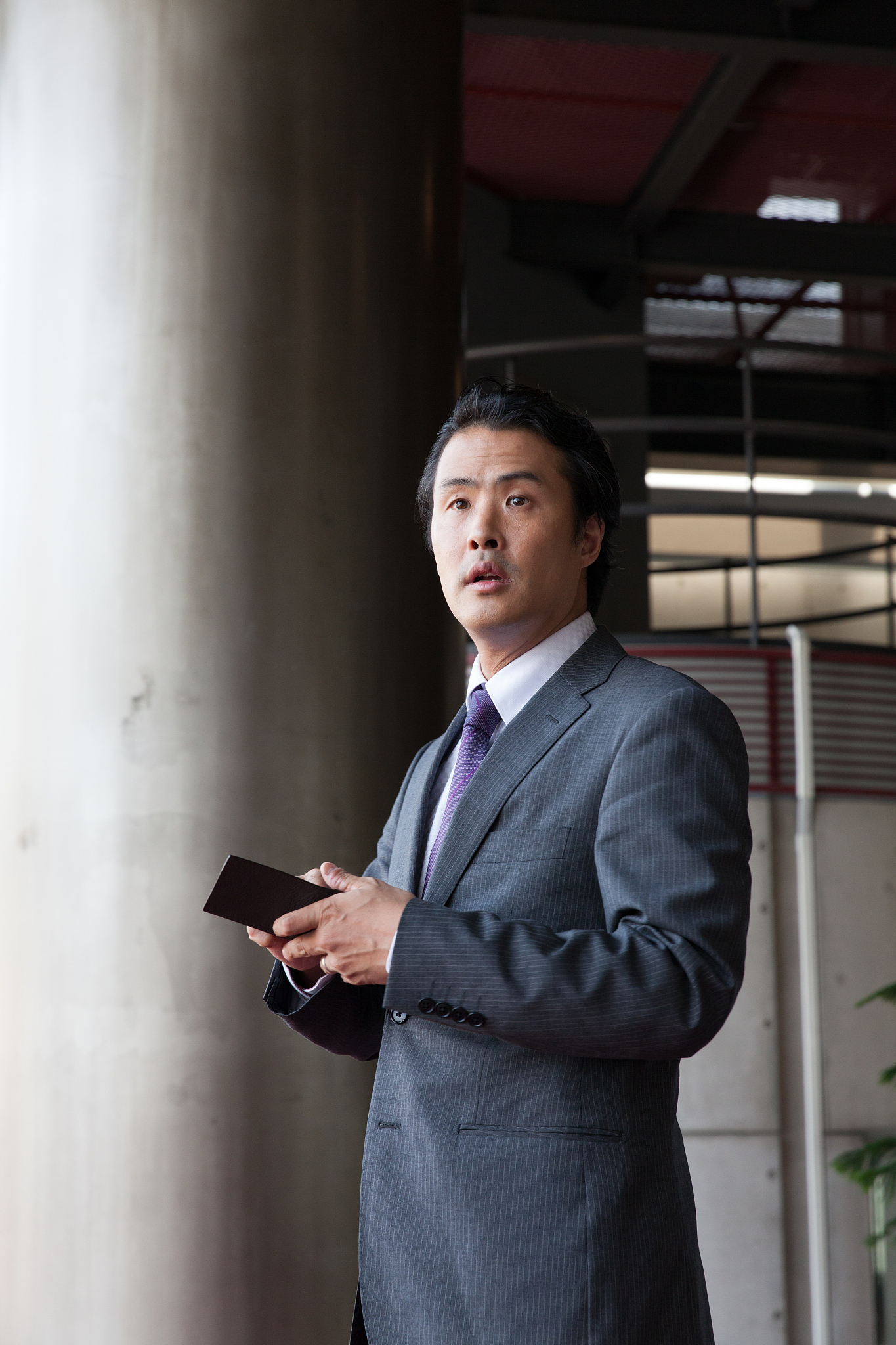 the businessman standing  in the lobby at office