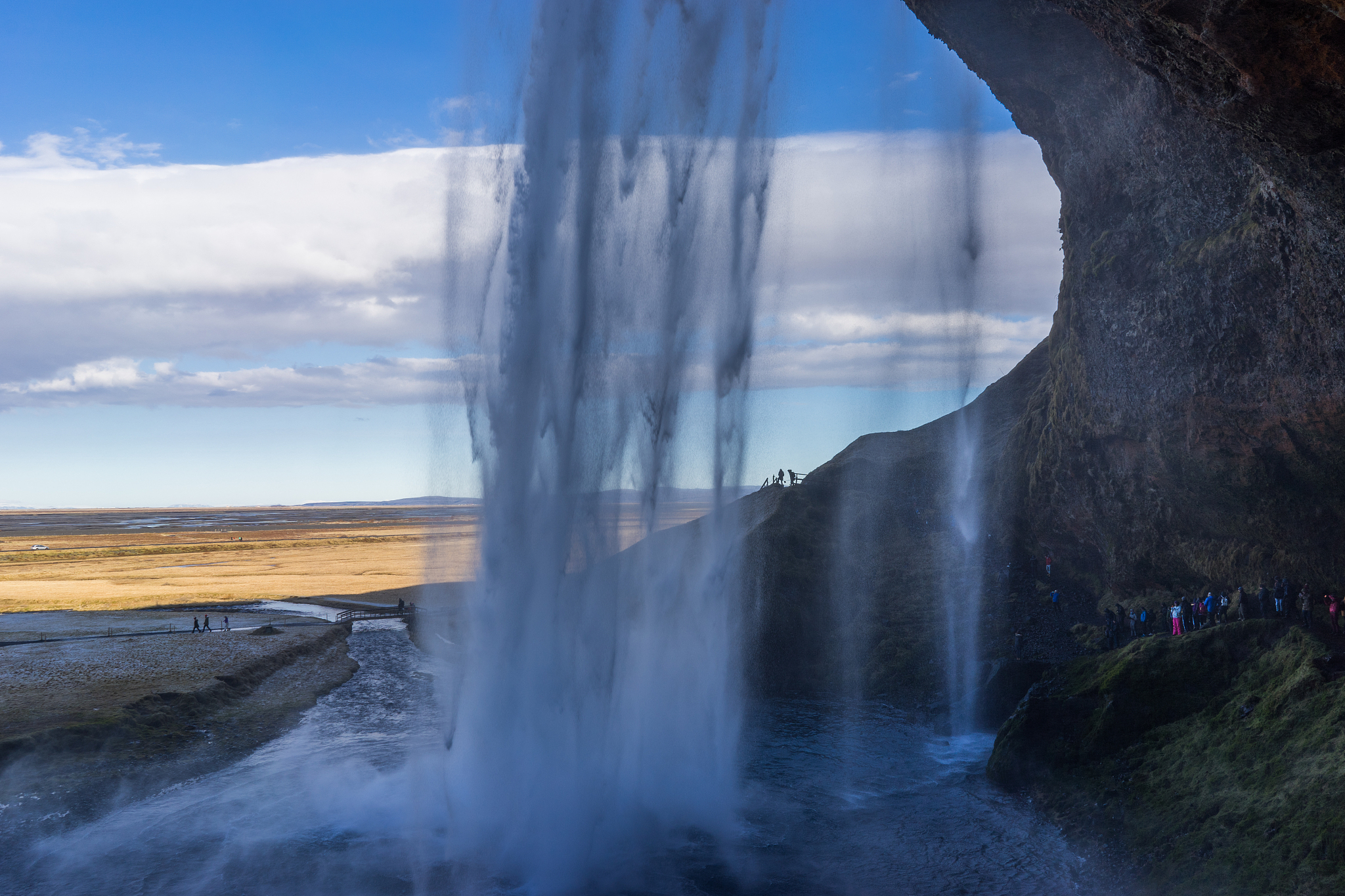 passage behind a waterfall in the mountains