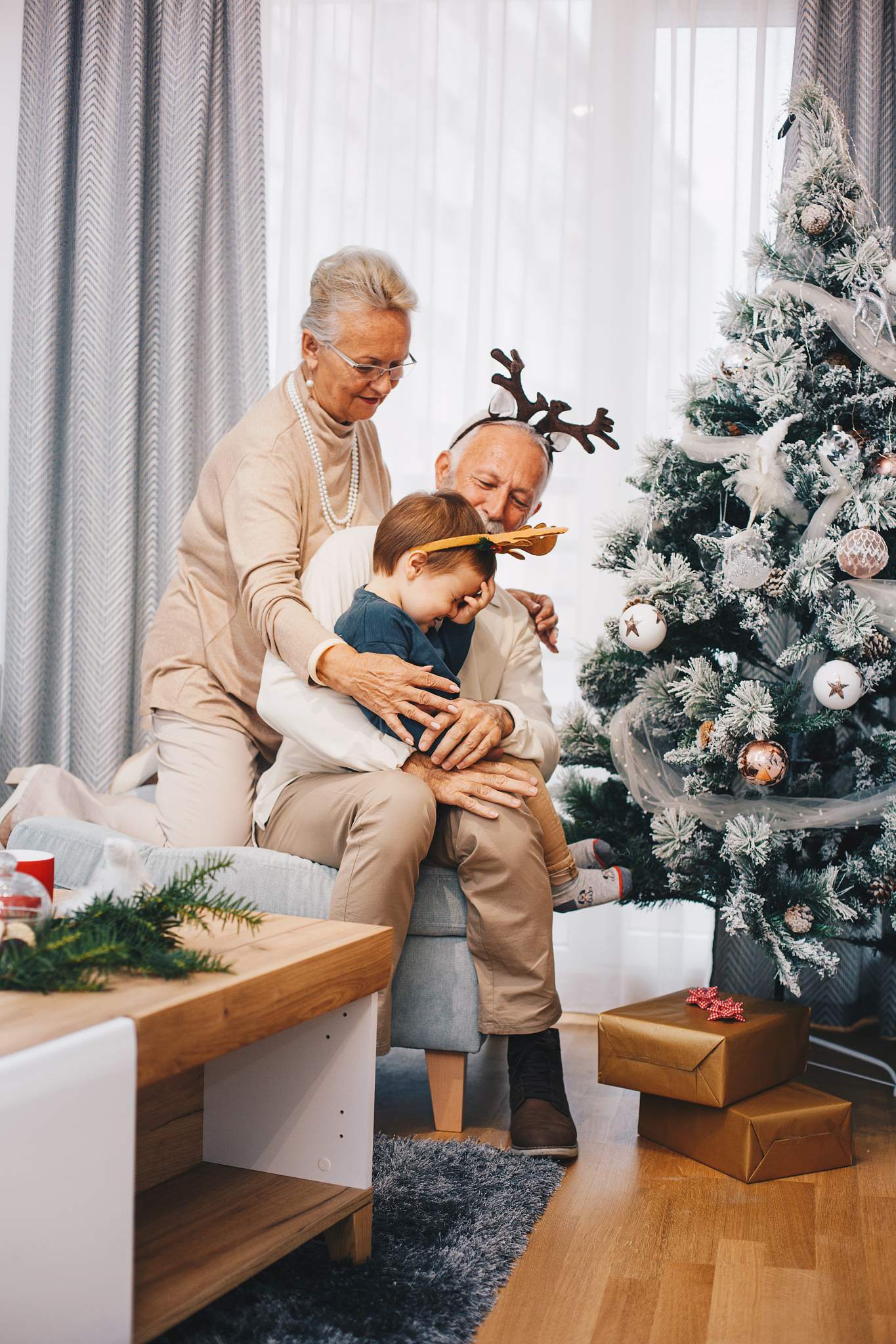 grandparents with grandson in their arms. christmas theme.