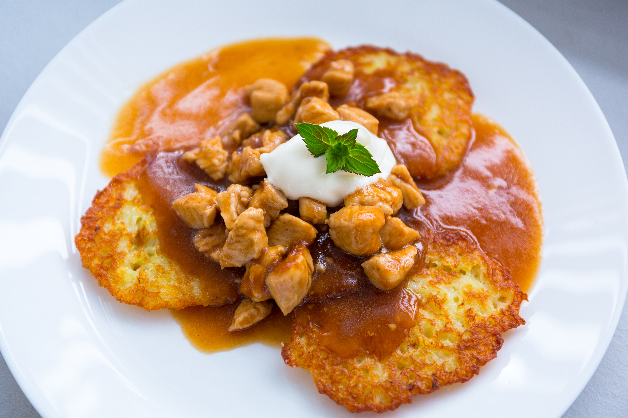 tasty dinner on a plate of hash browns