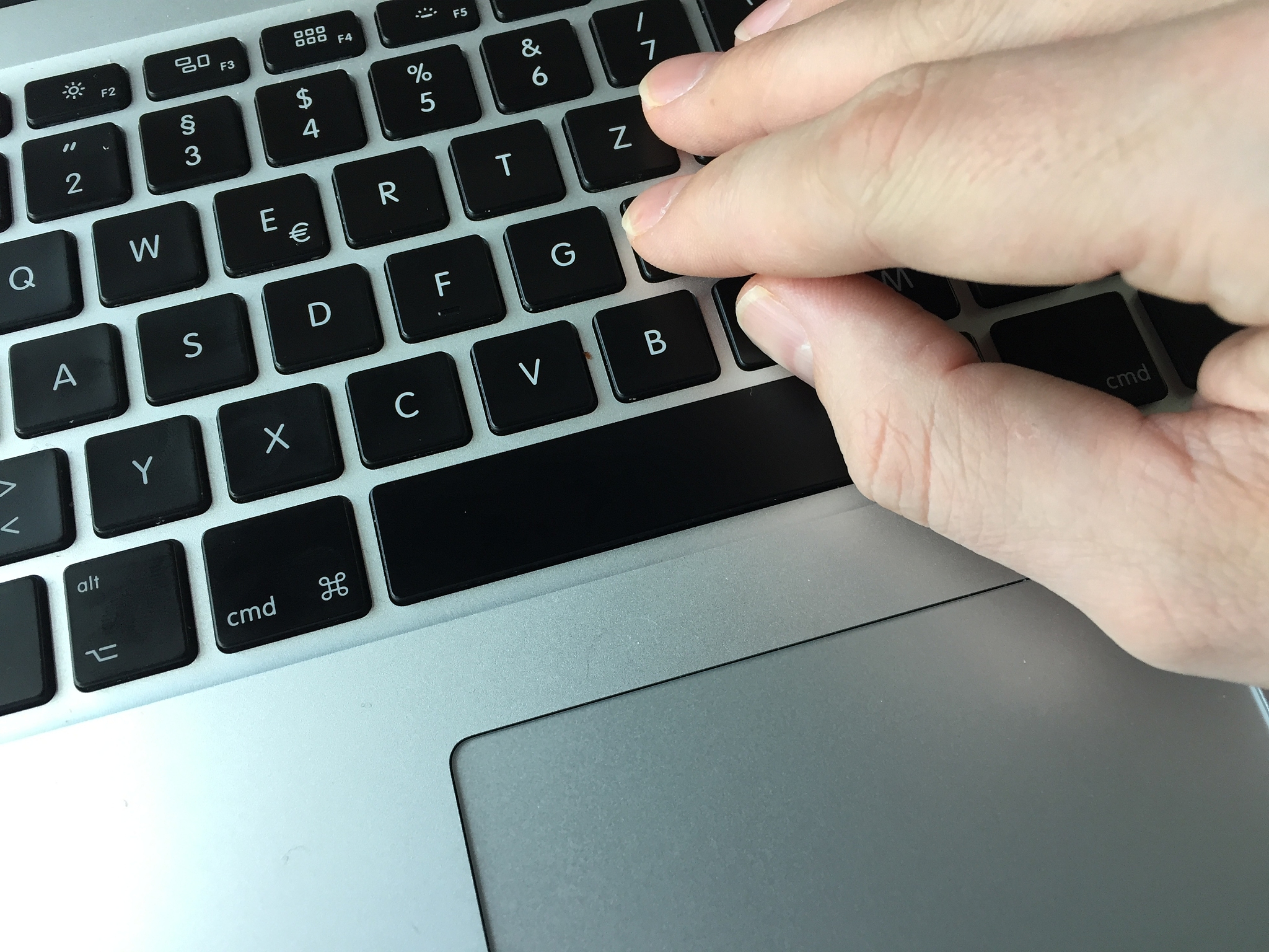 cropped image of person using laptop