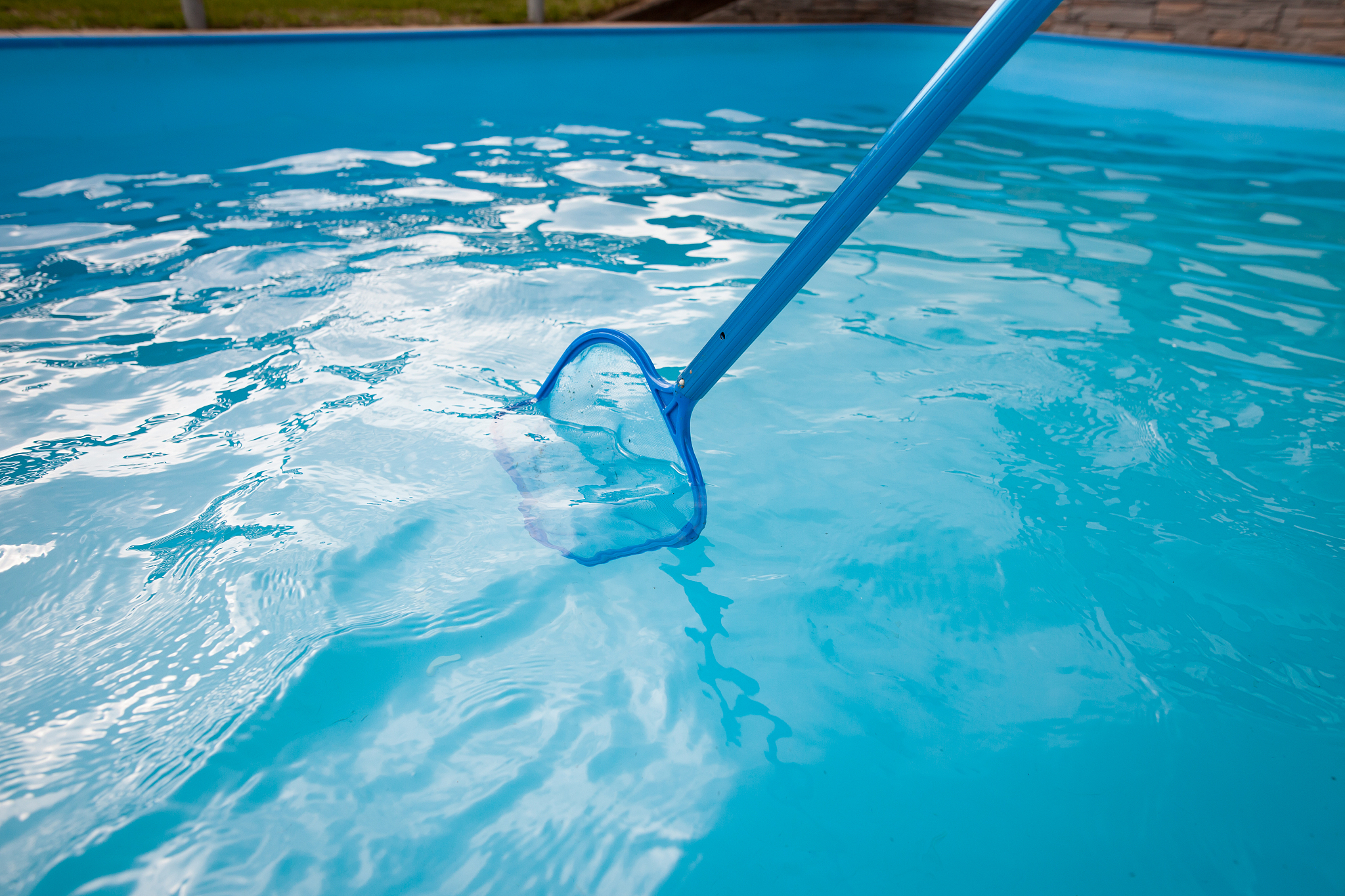 young man hands cleaning pool by net of the dust, maintenance