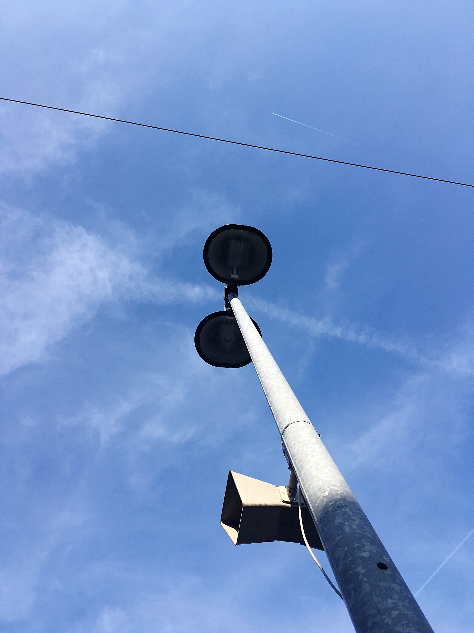 low angle view of megaphone against blue sky at railroad station