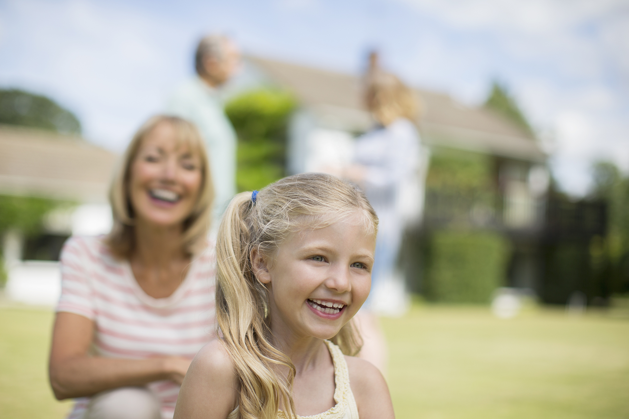 grandmother and granddaughter smiling outdoors