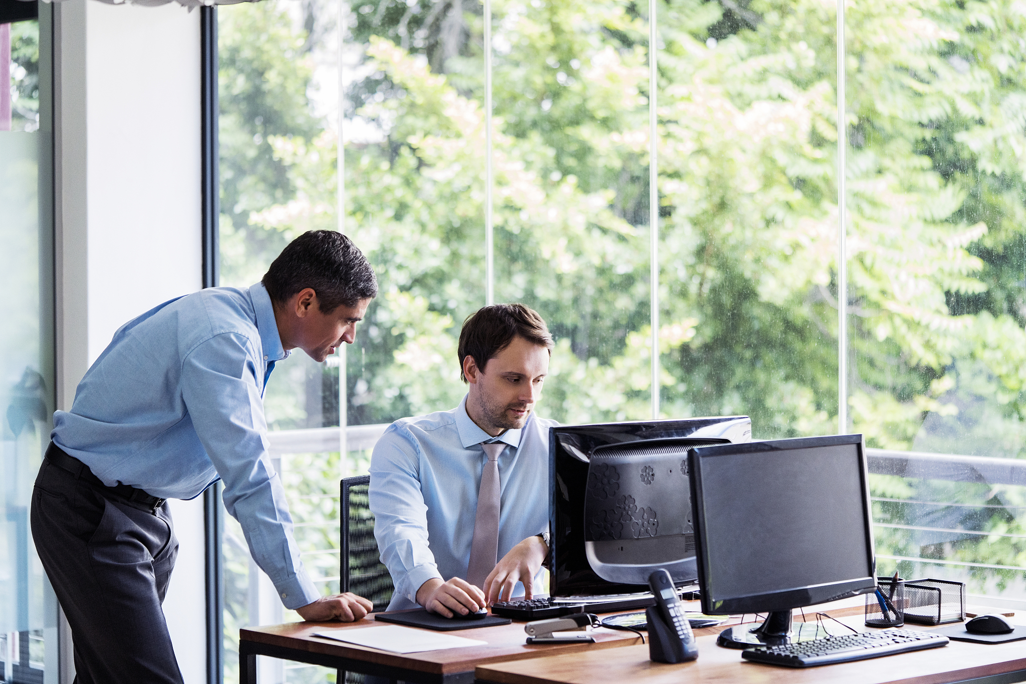 businessmen using computer on office desk