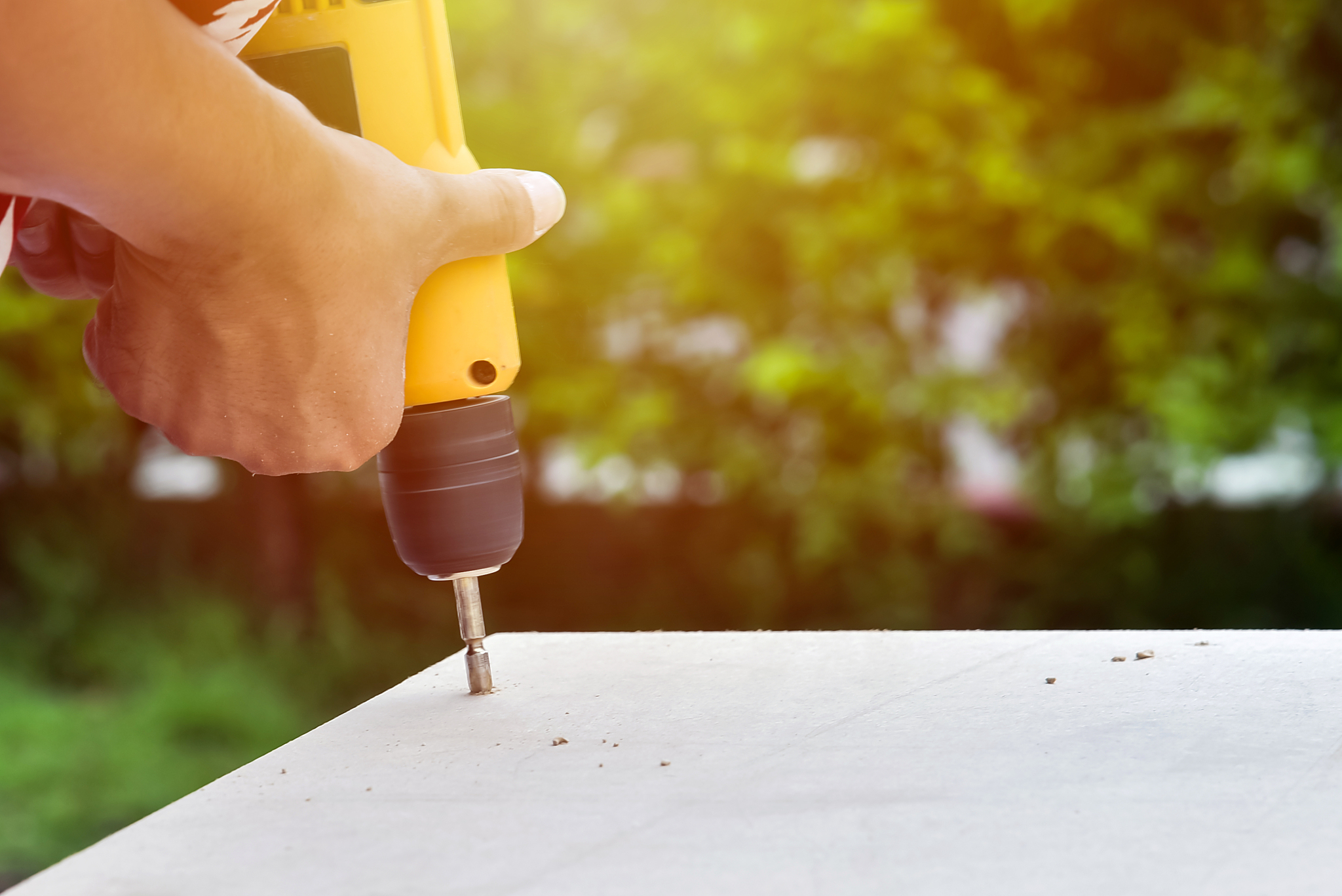 cropped hands drilling wood