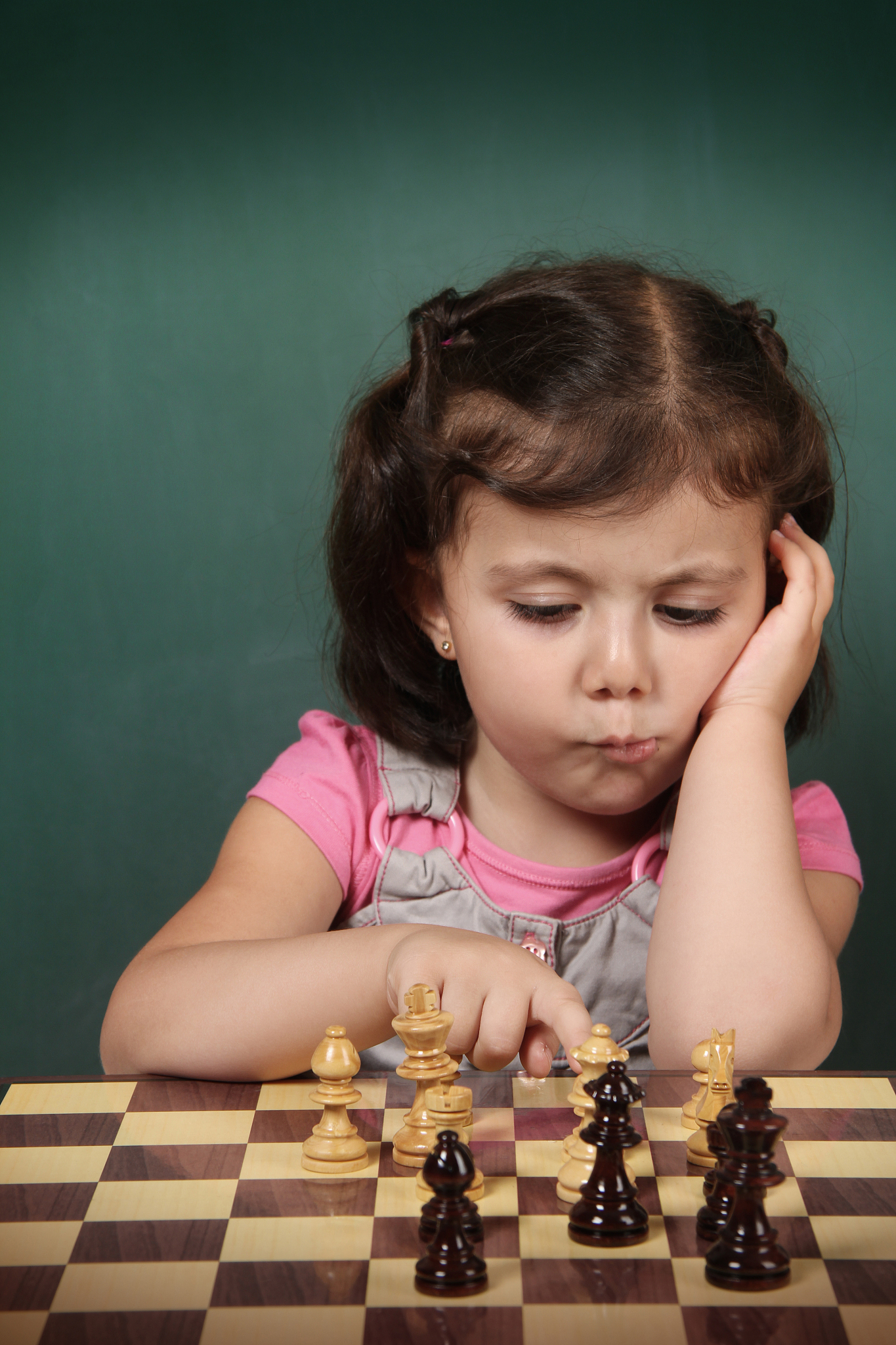 little girl play chess