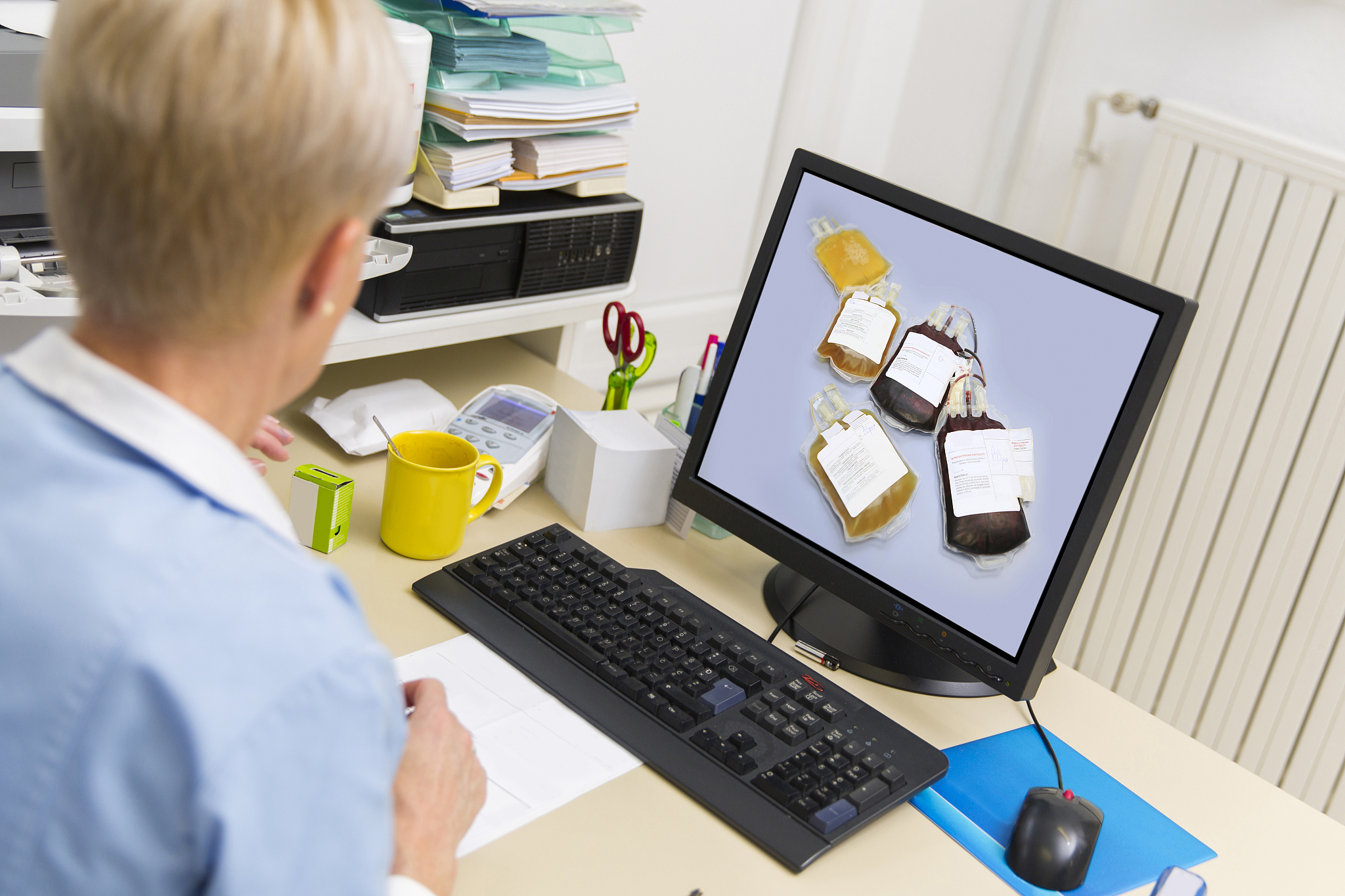 nurse at work,watching picture of blood bags on monitor