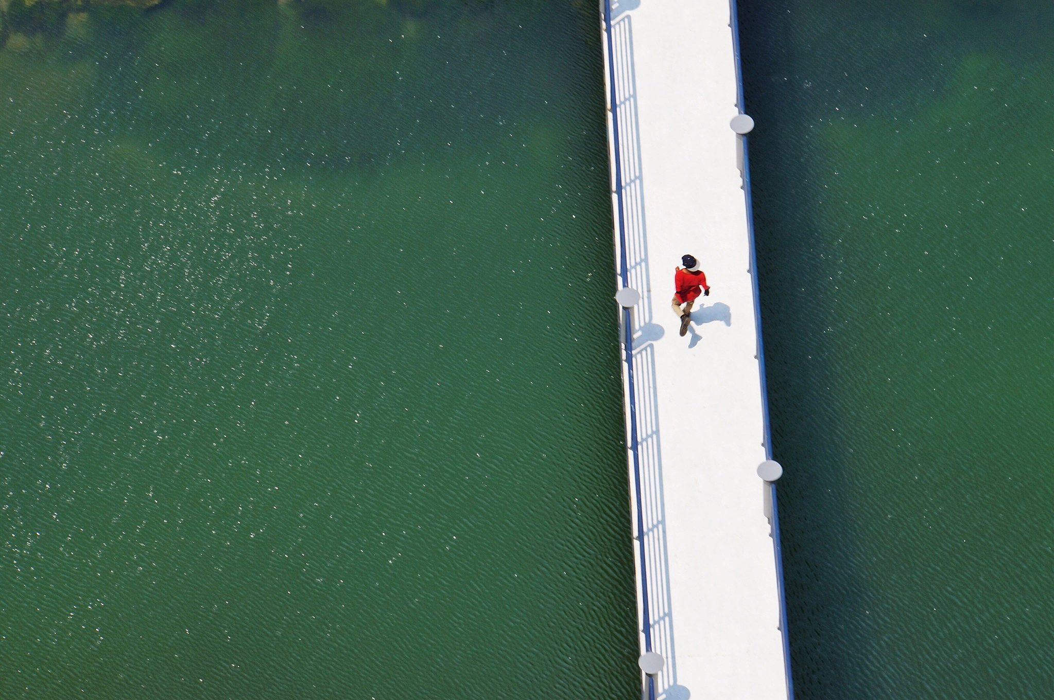 high angle view of man running on pier over sea