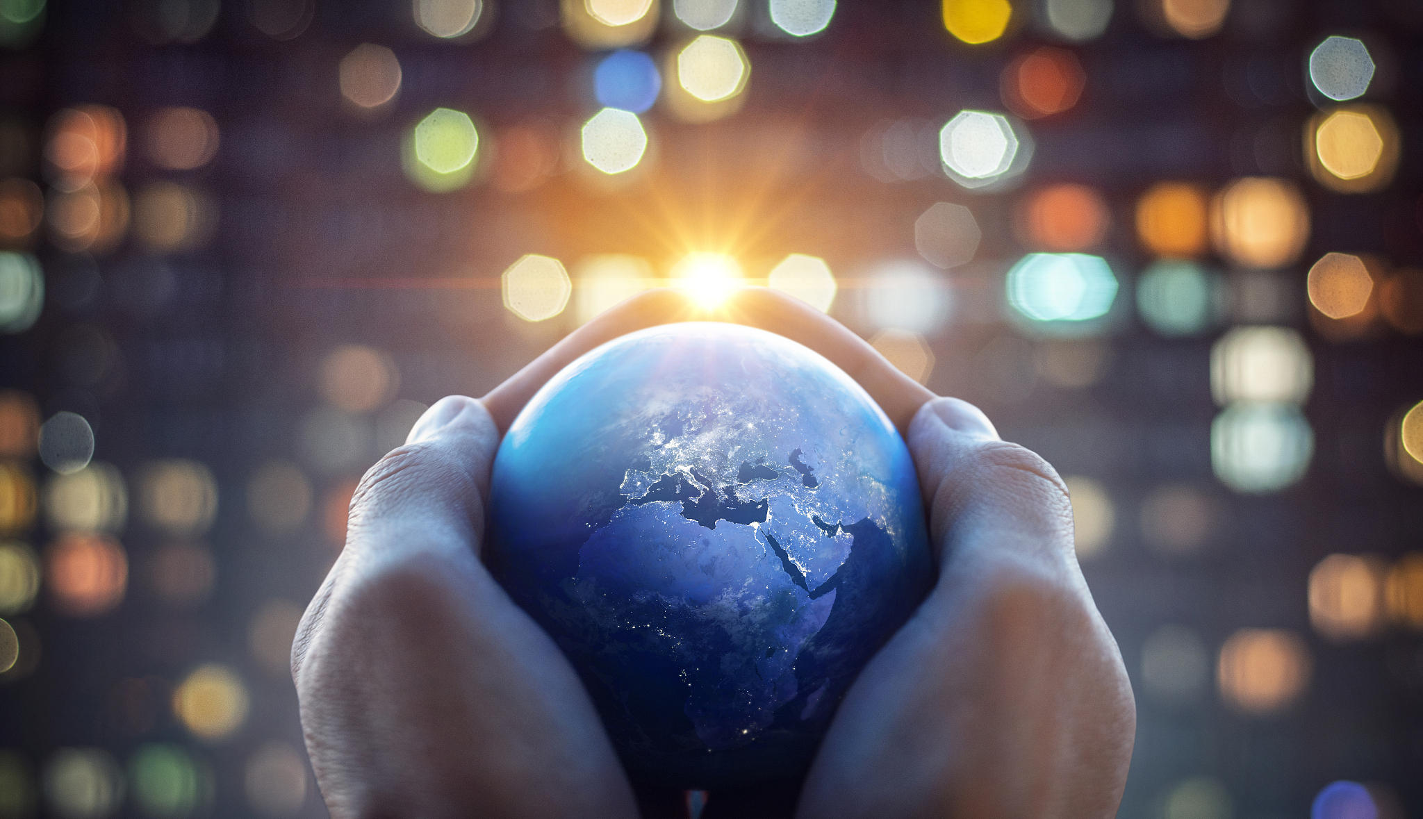 the globe earth in the hands of man against the night city.