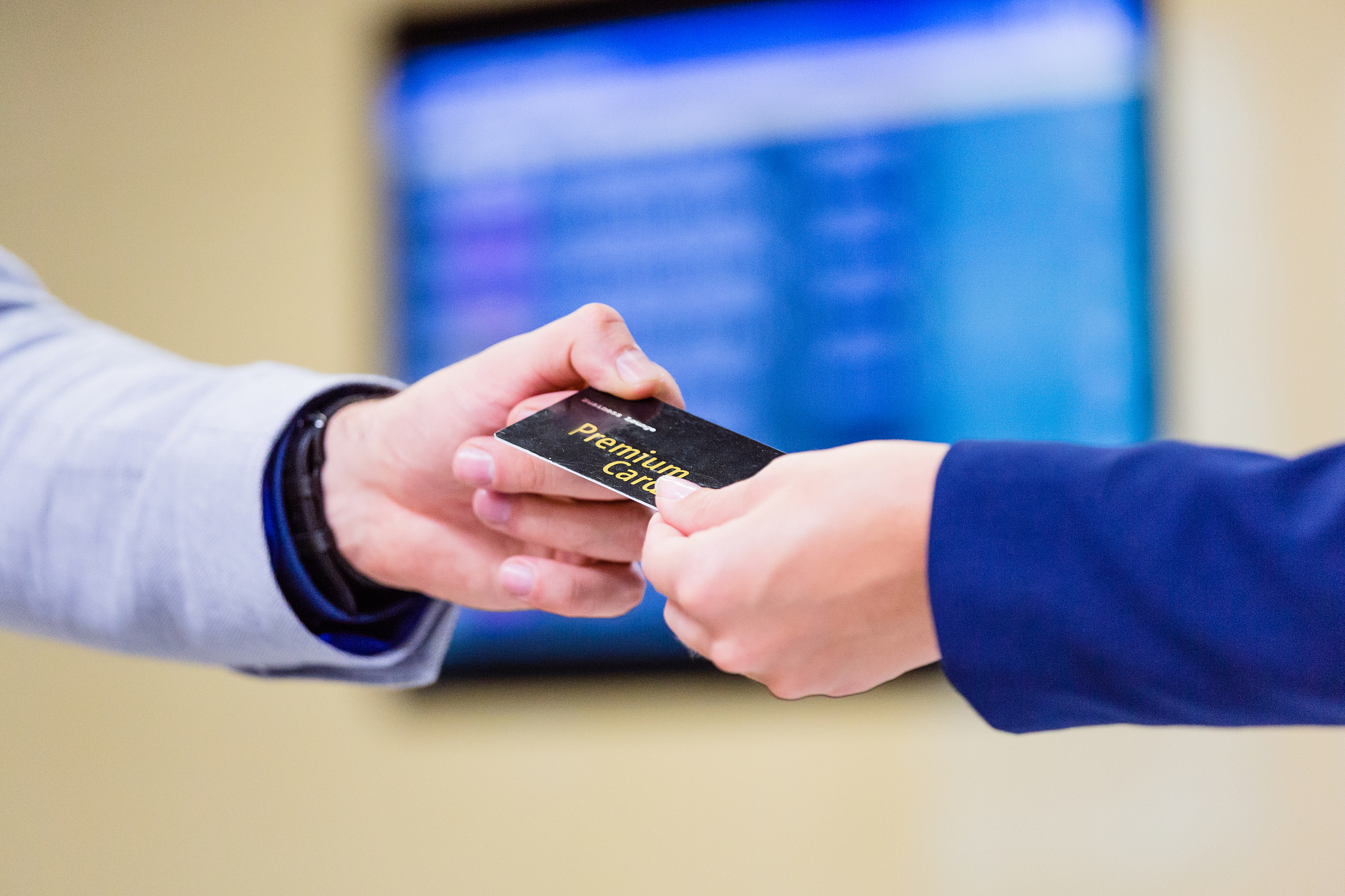 man giving business card to airport vip lounge