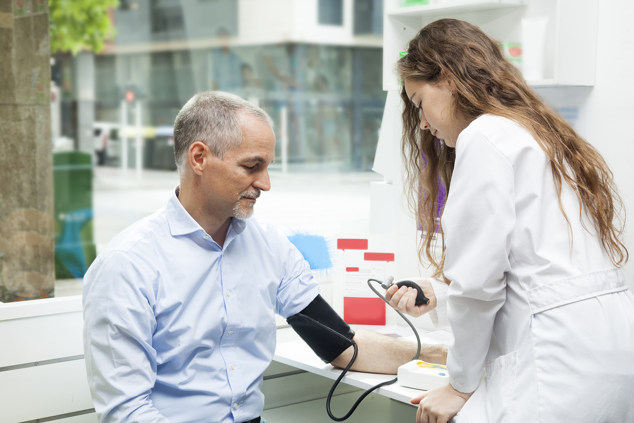 girl taking blood pressure to mature man