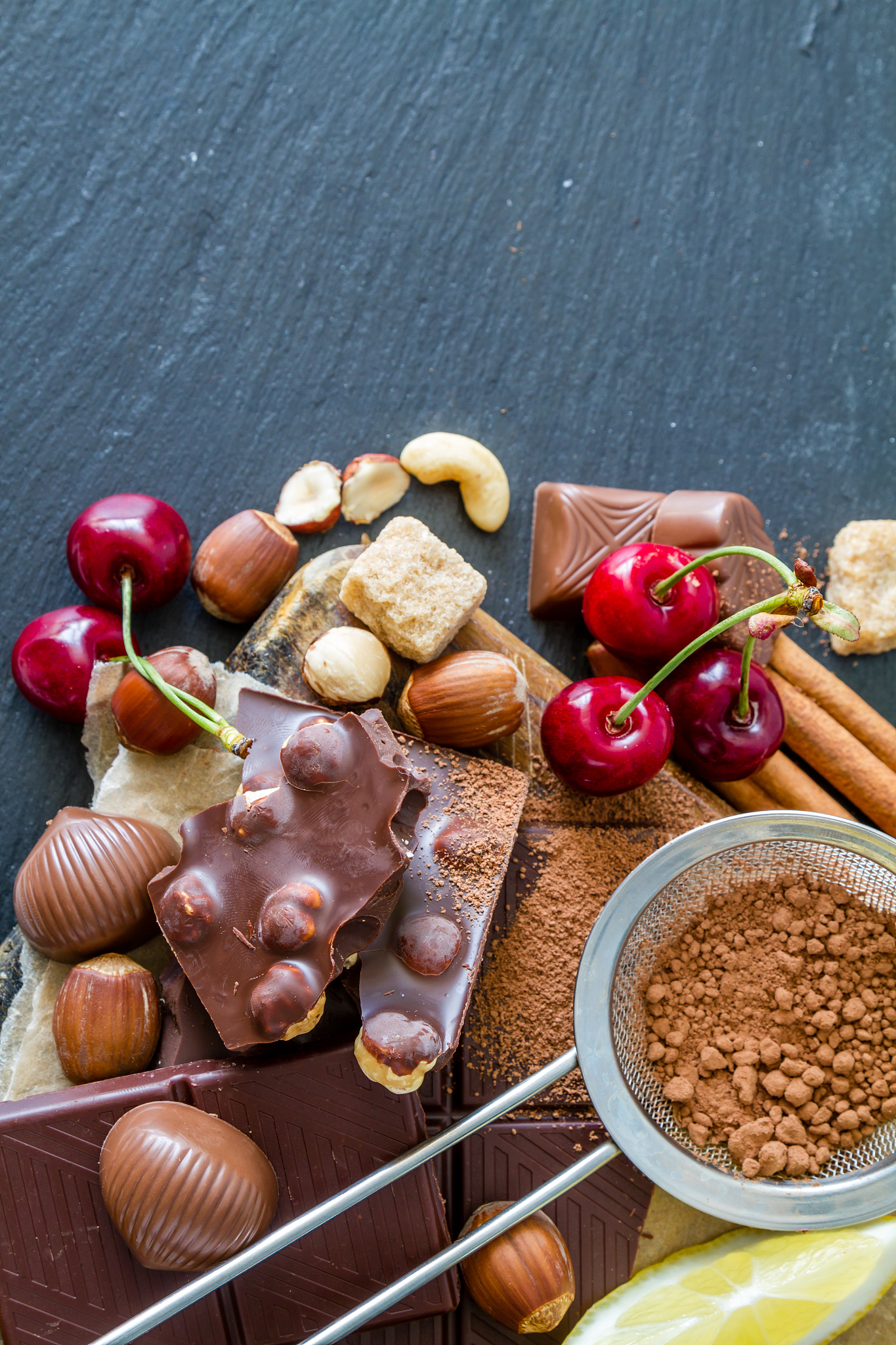 chocolate, candy, nuts, cinnamon, berry, wood board