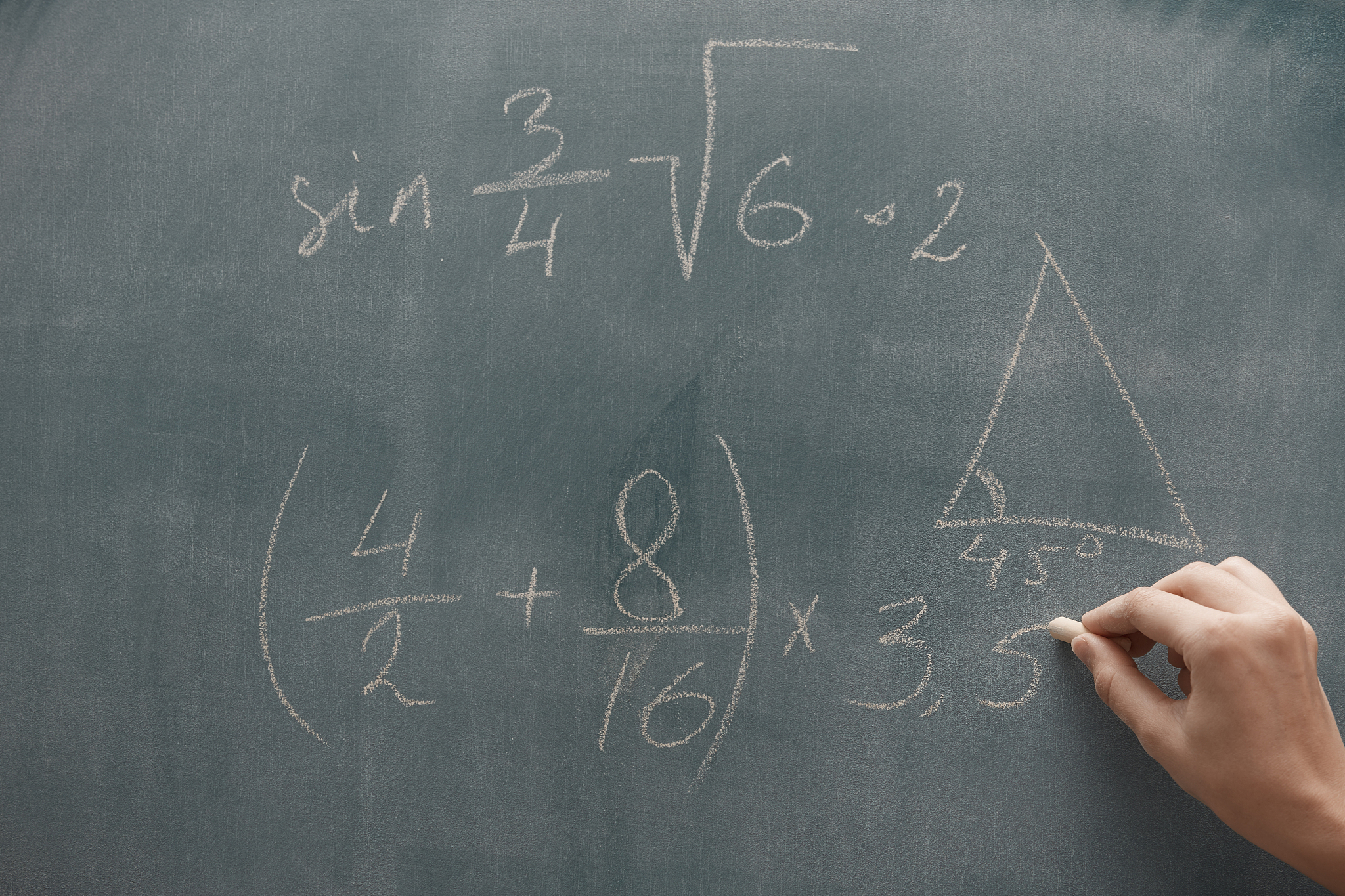 hand of student studying mathematics and writing on a blackbroar