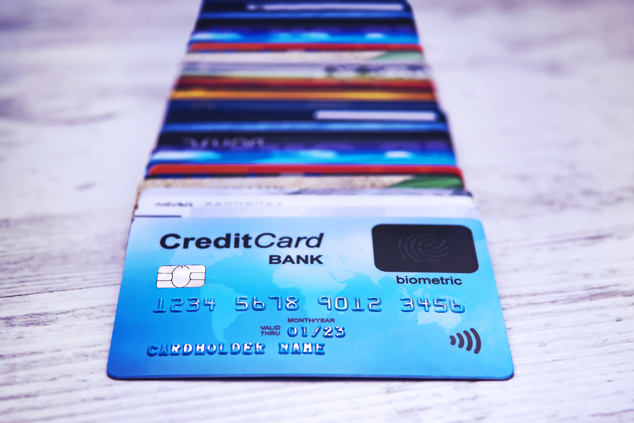close up of credit cards stack on wooden surface. bunch of payme