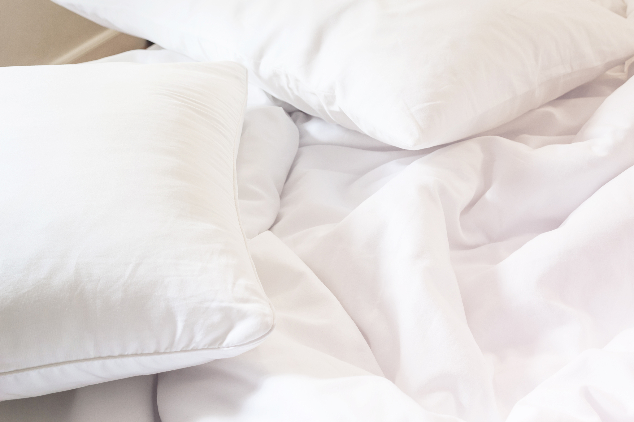 white pillow on bed and with wrinkle messy blanket in bedroom, f