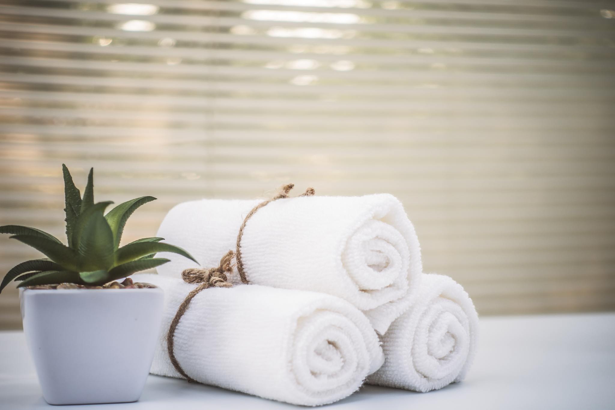 beautiful spa composition white towel on wooden table.