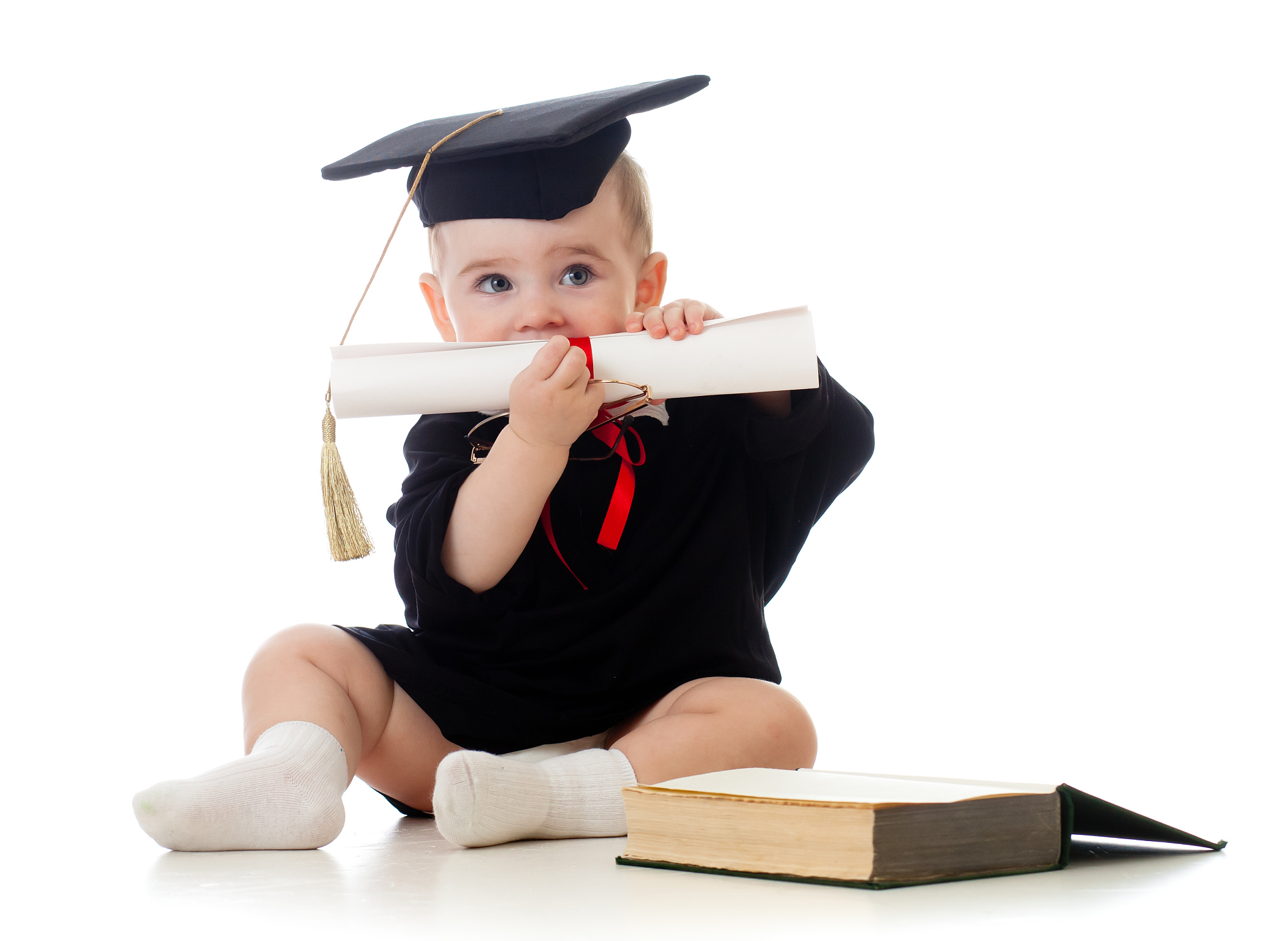 baby in academician's clothes  with roll and book