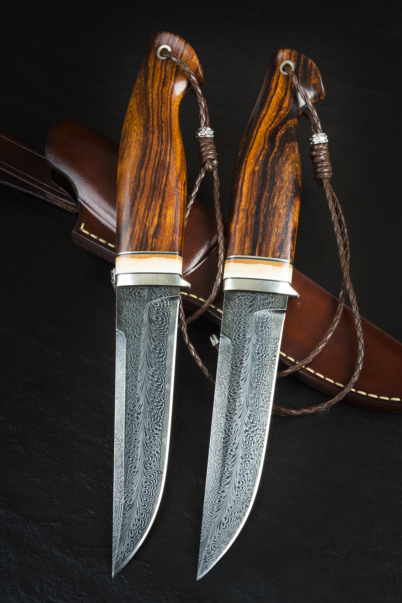 hunting knife from damascus mosaic with mammoth tusk on a black 