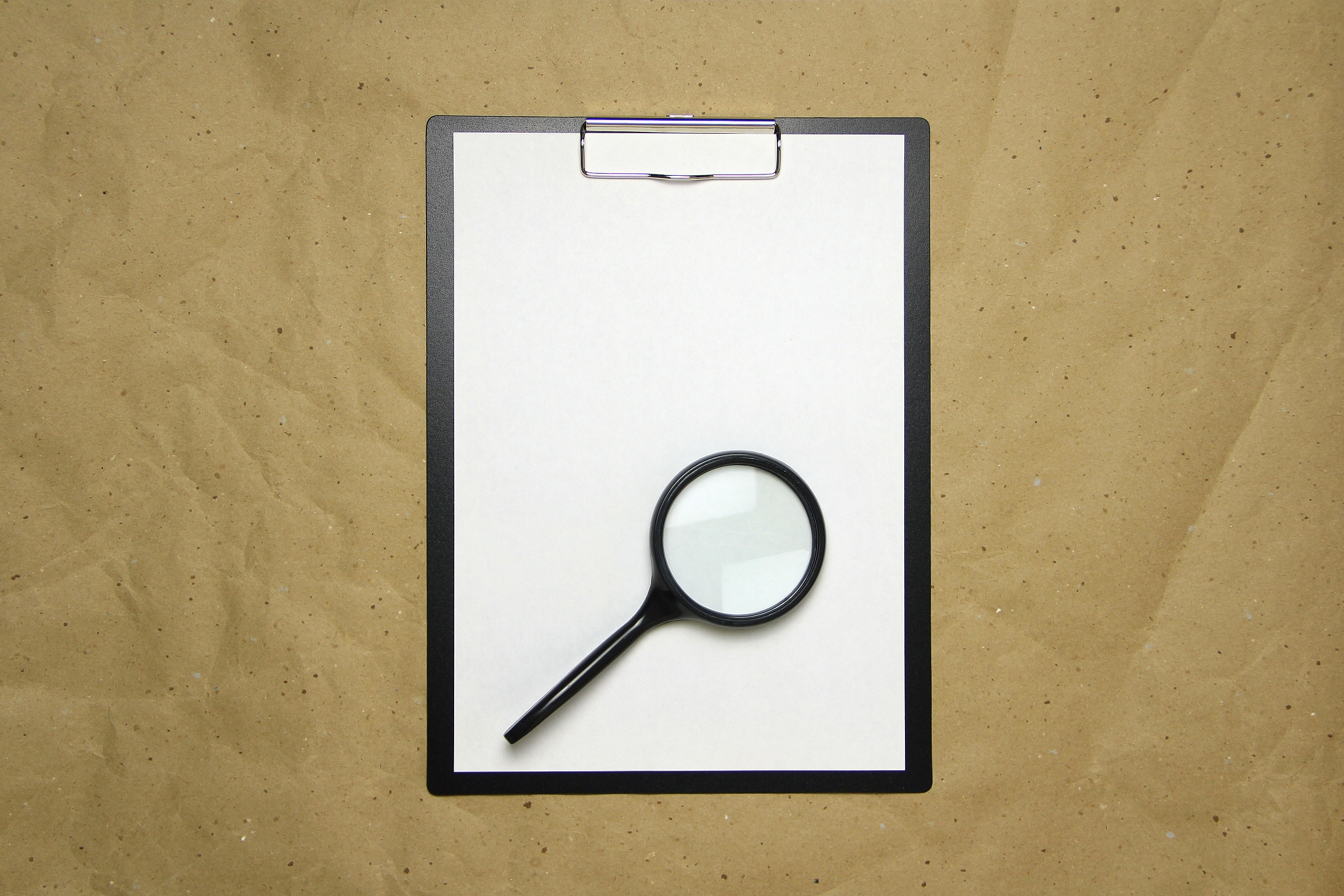 a tablet with a white sheet of a4 format on a beige craft paper