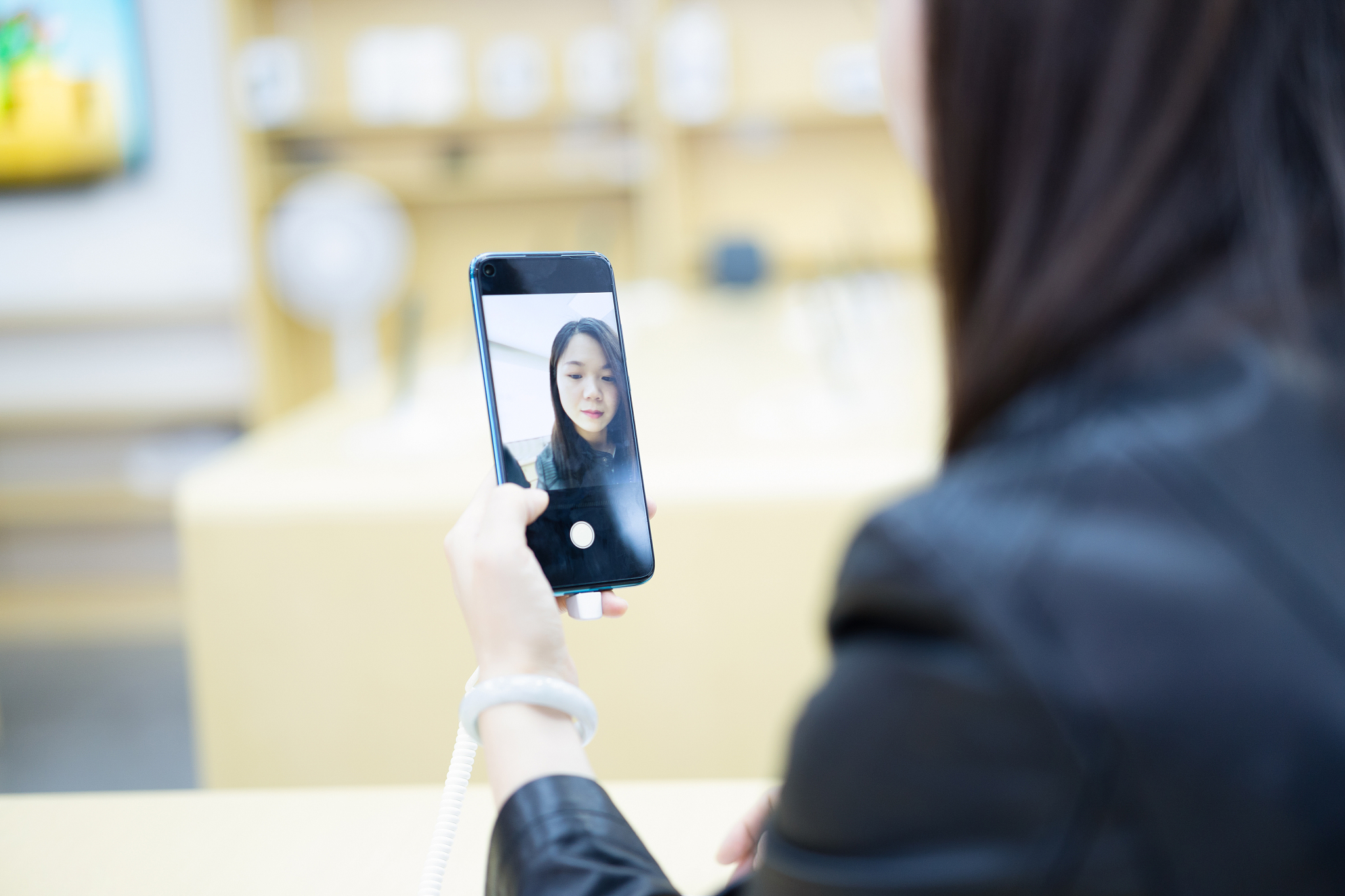 female choose smart phone in phone store