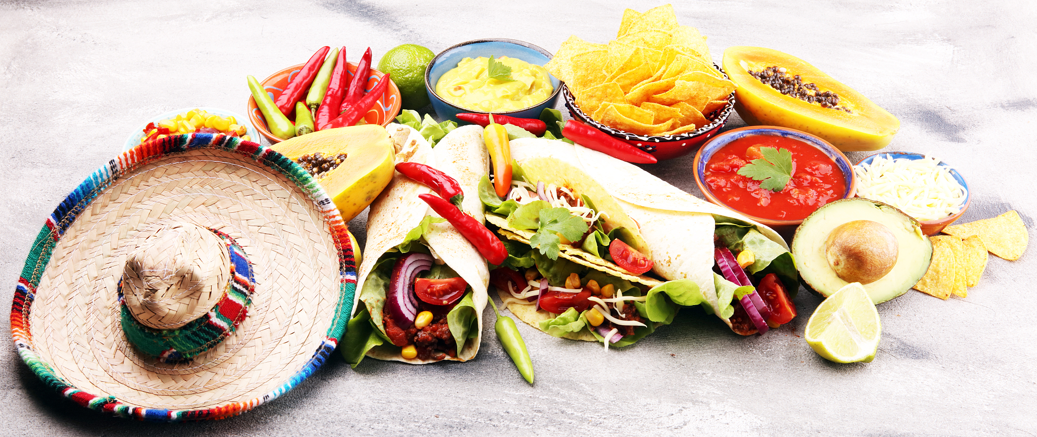 mexican food, including tacos, guacamole, nachos and pepper on r