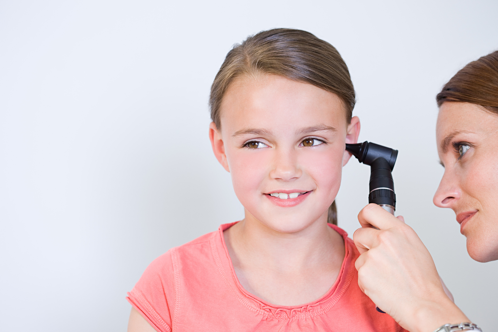 doctor looking at girls ear