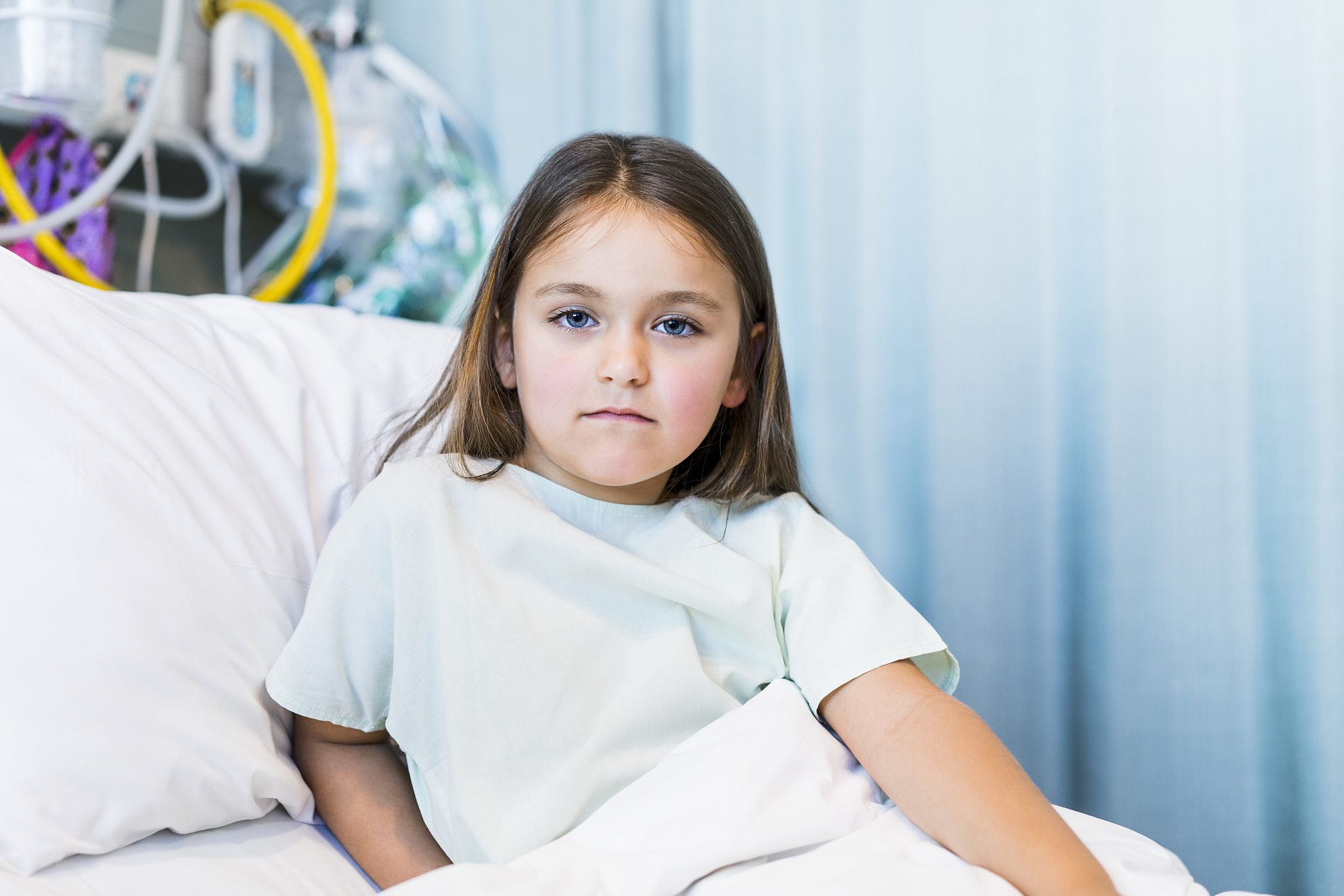 portrait of patient lying on bed in hospital