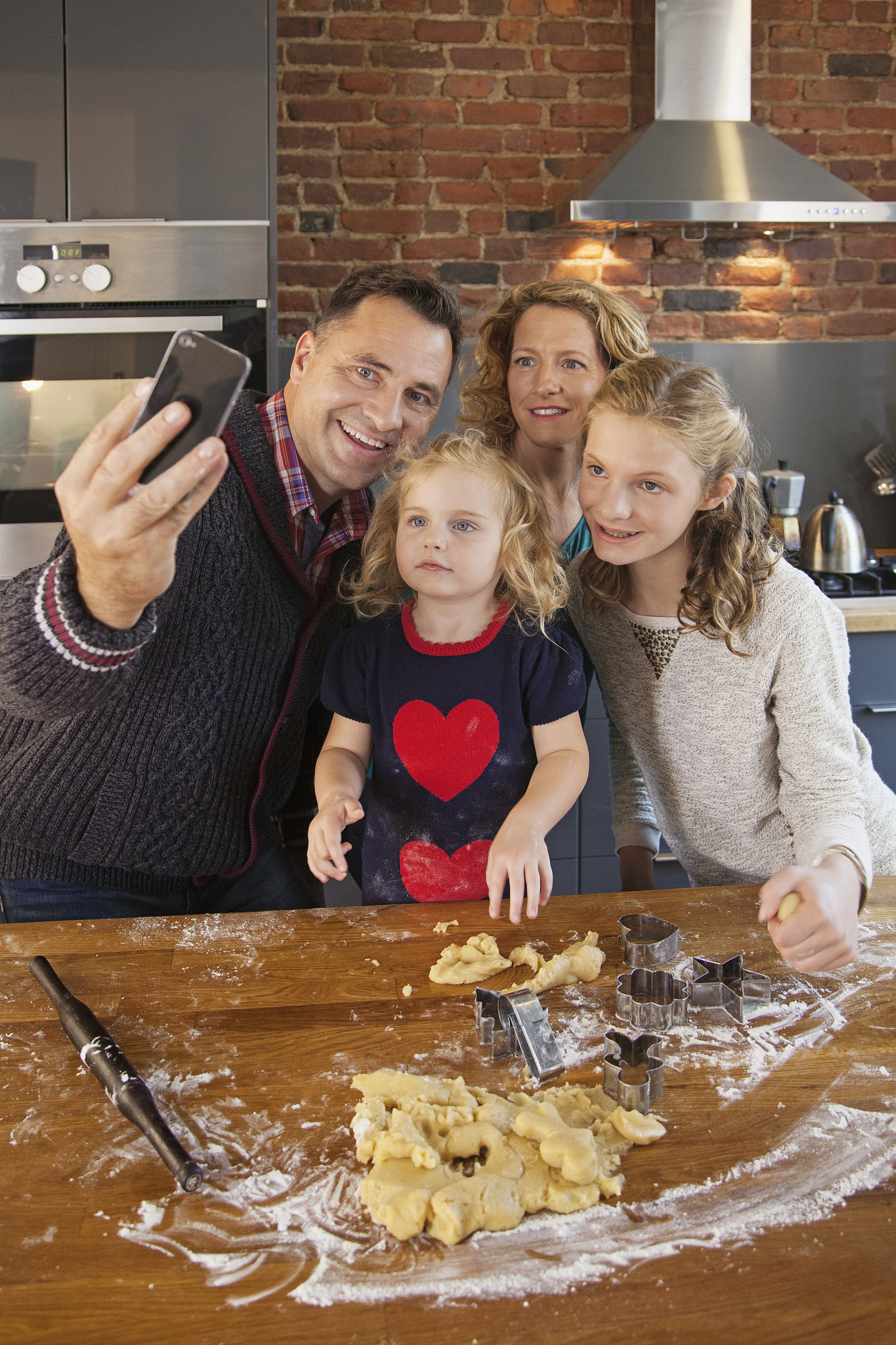 family taking selfie in kitchen