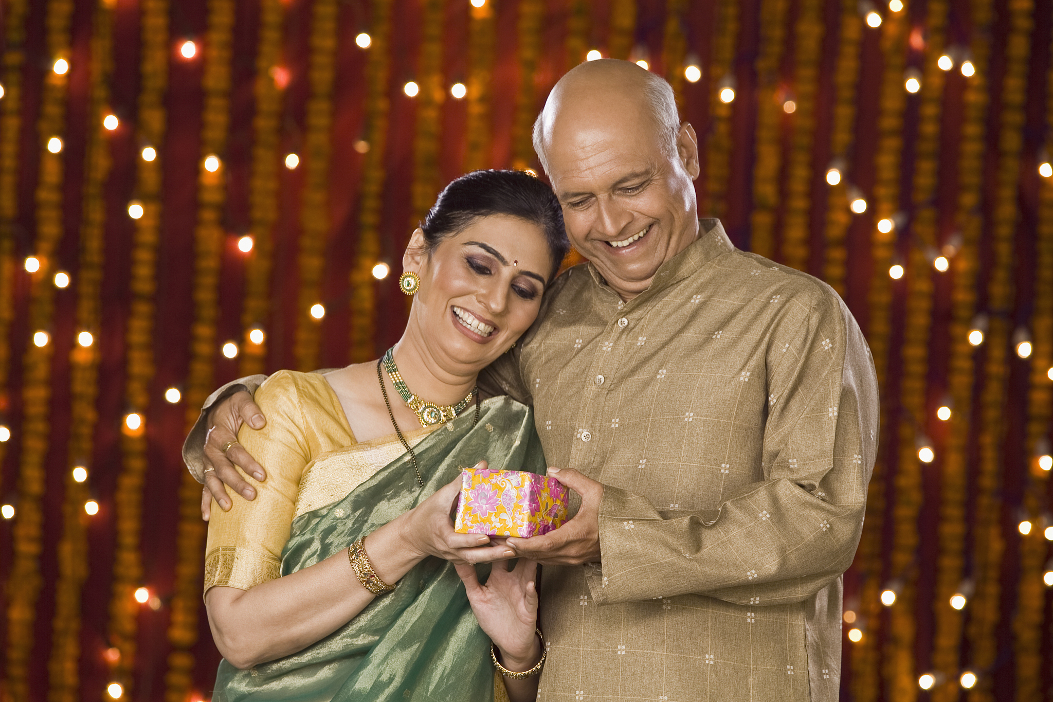 man giving diwali gift to his wife