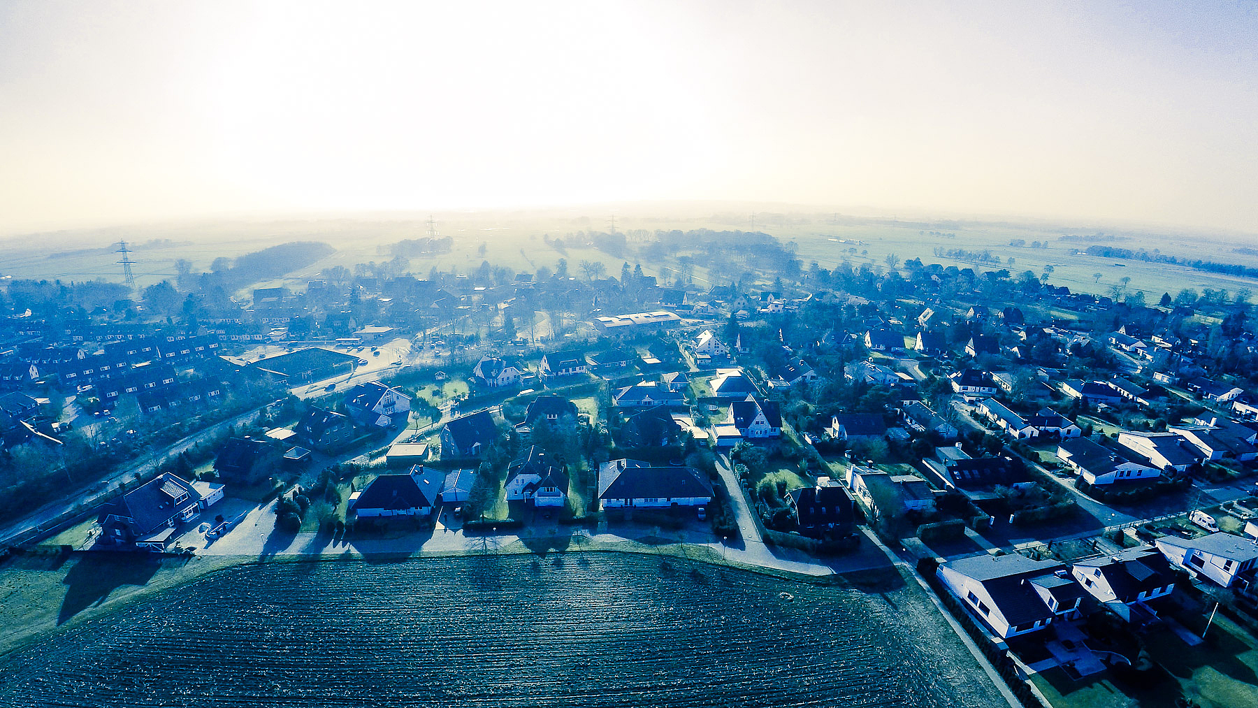 high angle view of houses against sky during sunny day