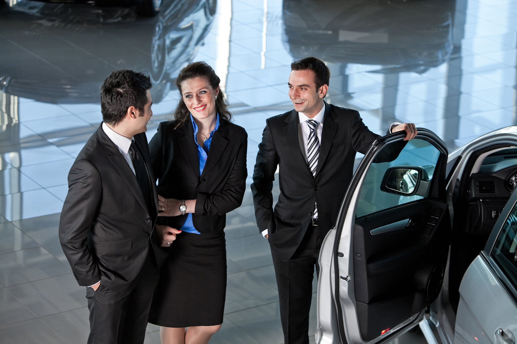 car salesman and couple buyer