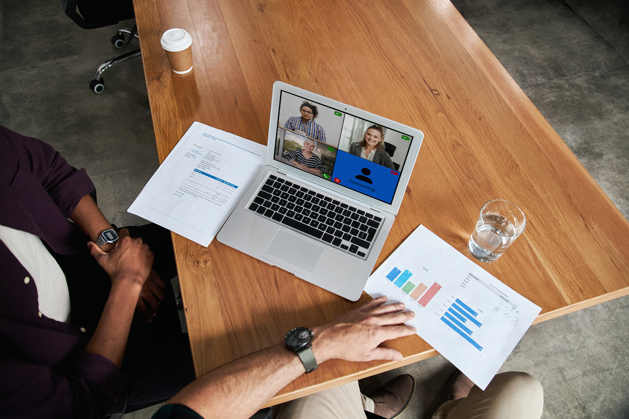 businesspeople video conferencing with a colleagues working at h
