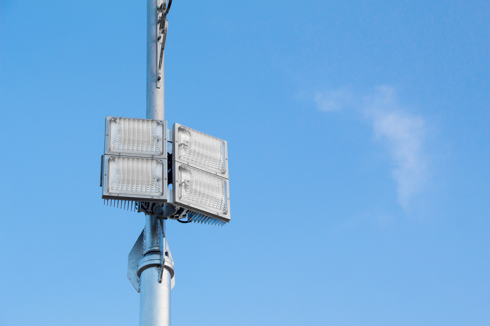 silver lamp post with a light led bulb on the left side and back