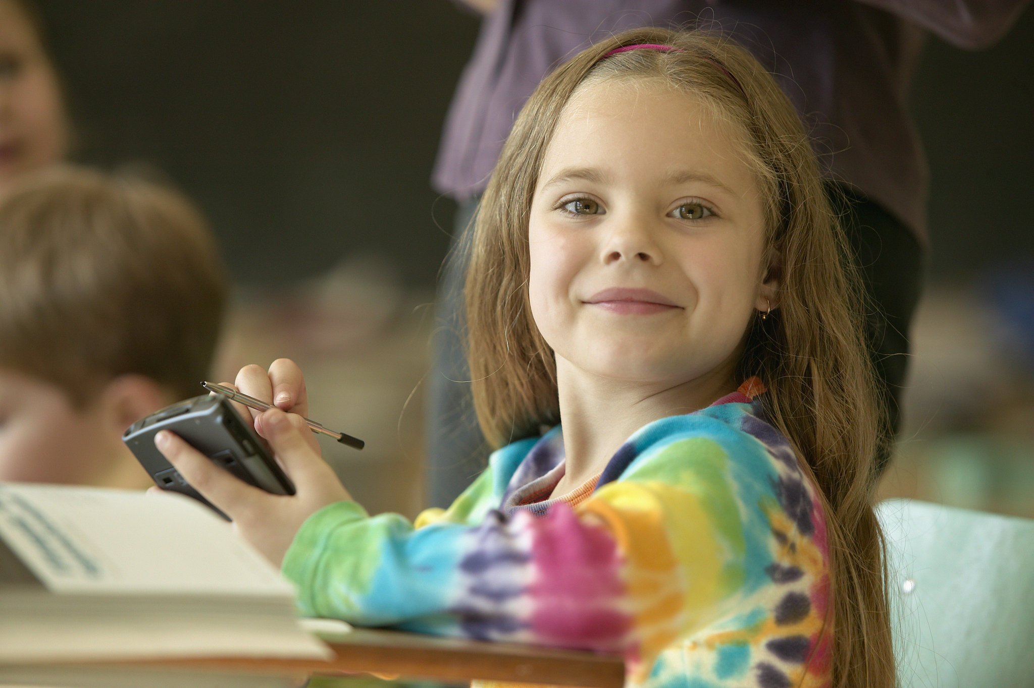 girl using pda in classroom
