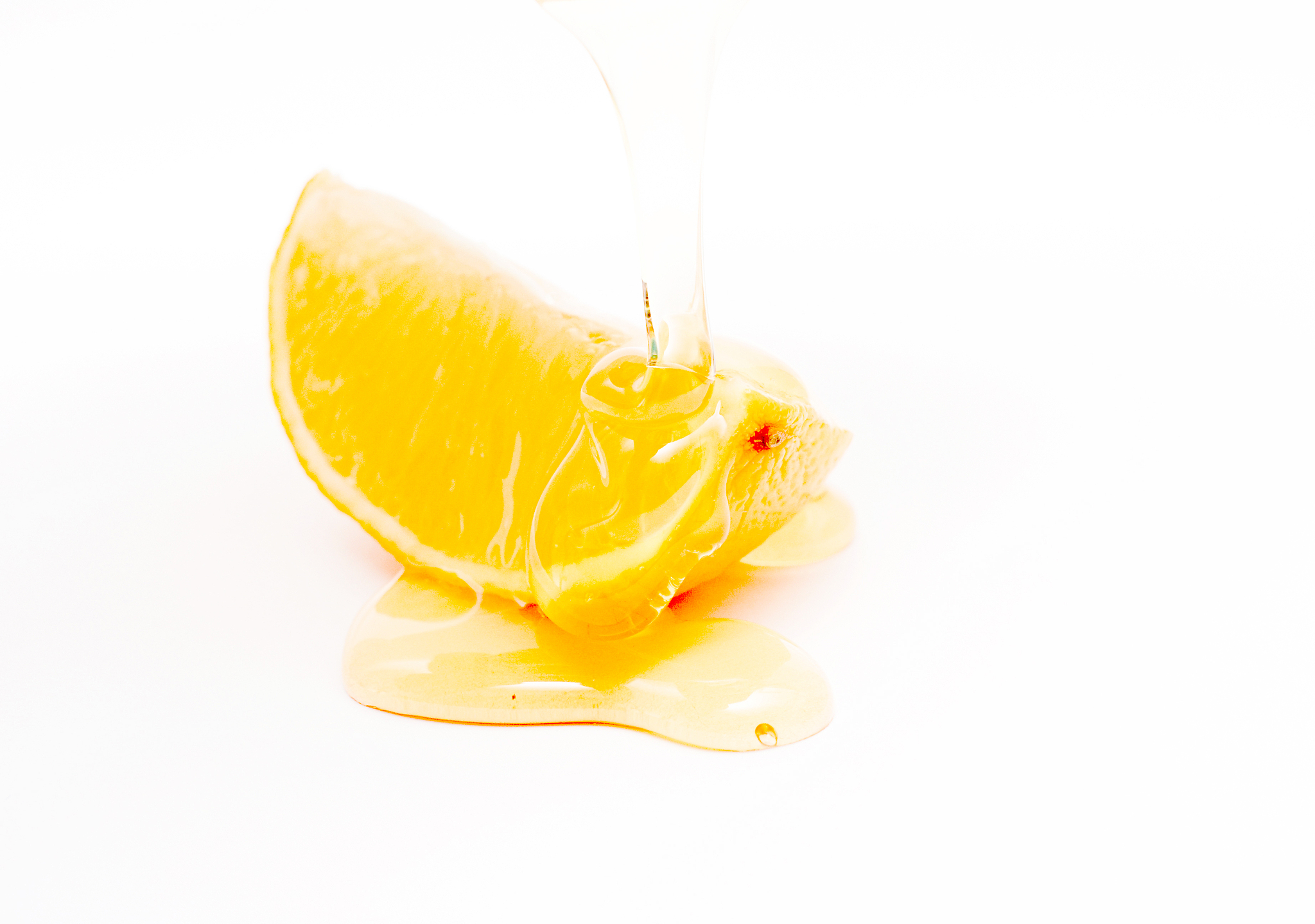 slice of lemon and honey , shallow dof, white background