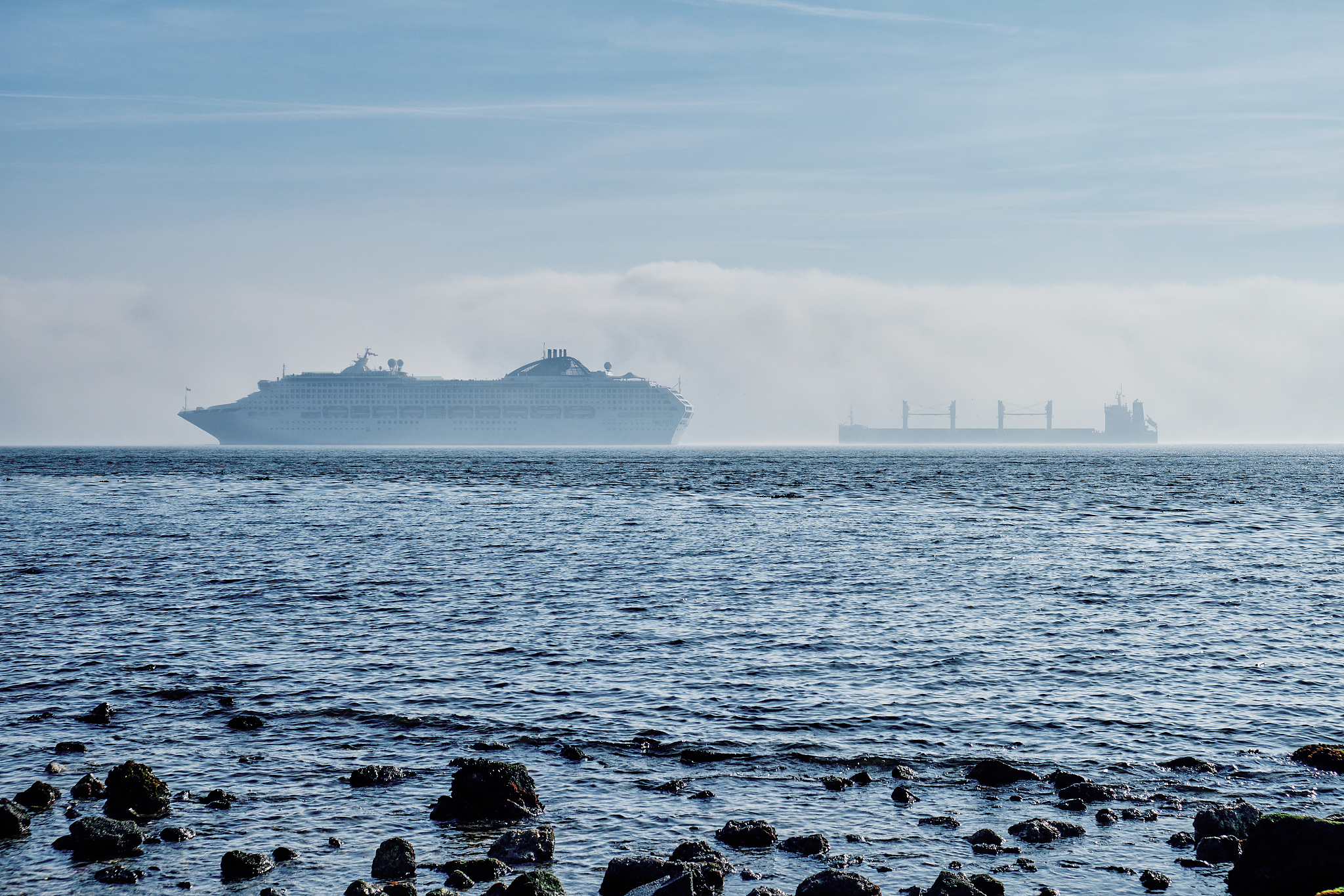 cruise ship and cargo ship off the coast of lisbon.